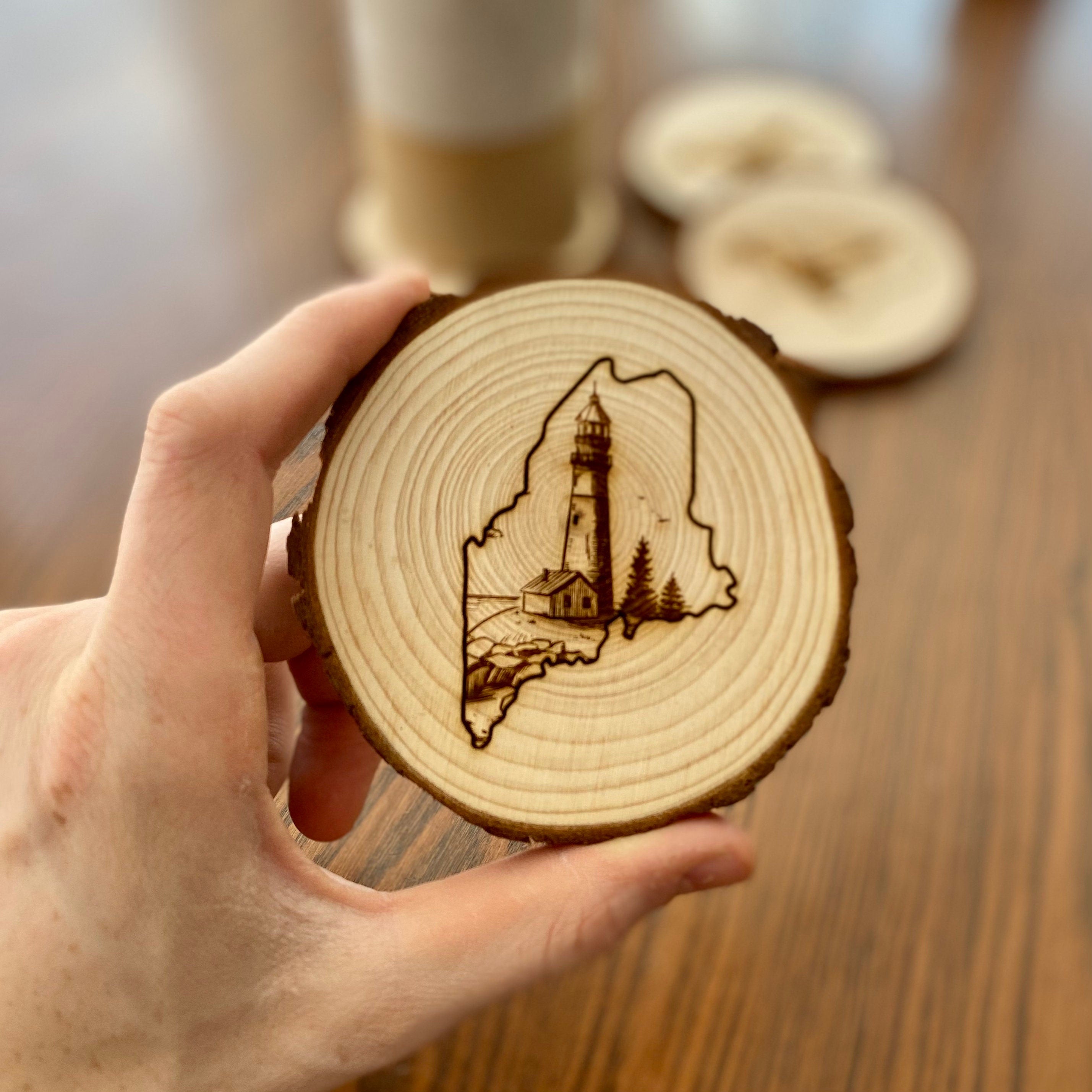 Maine Lighthouse Engraved Wood Coaster Set featuring state outline and coastal scene.