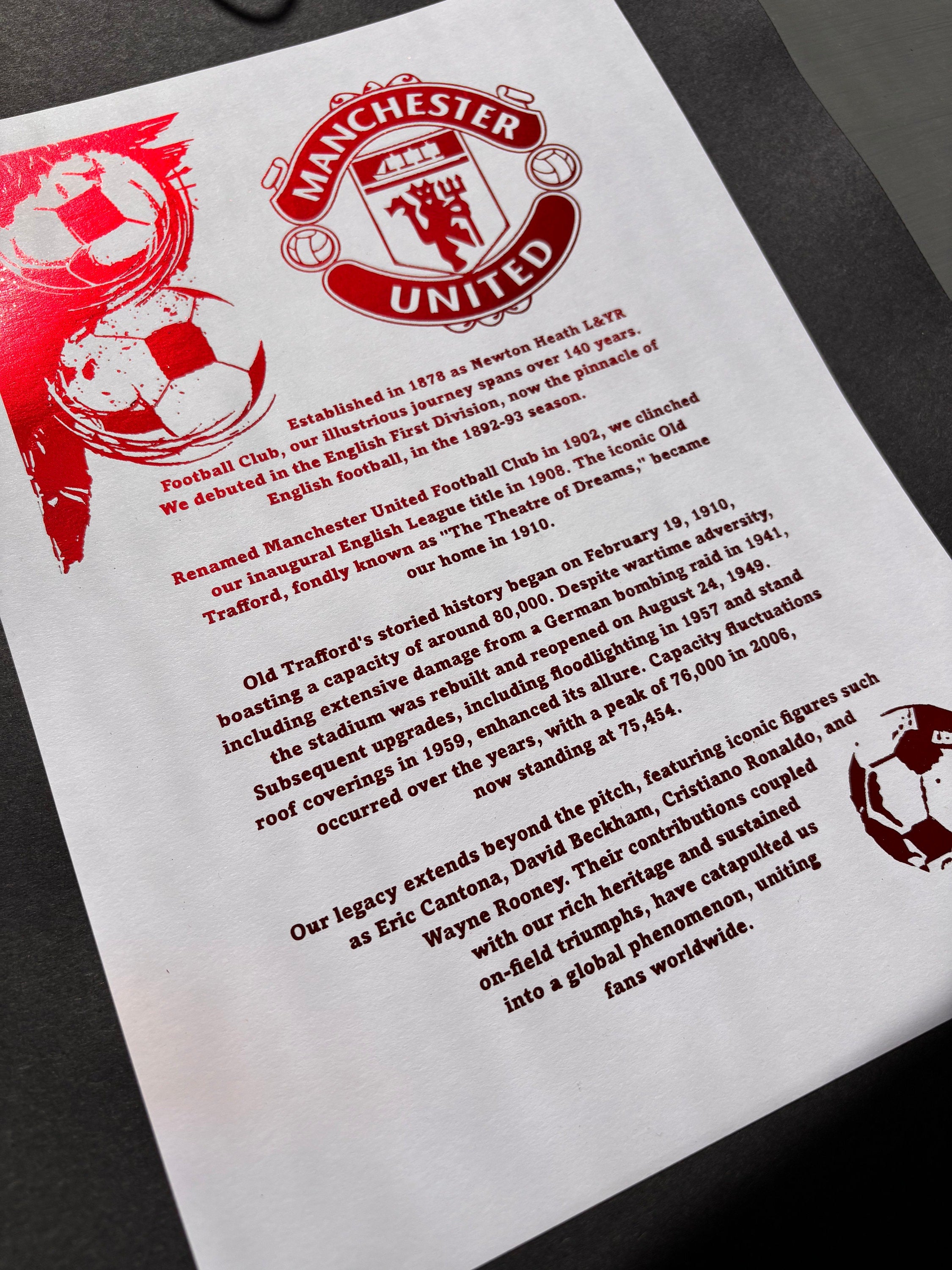 A4 foil print featuring the Manchester United FC logo in vibrant red foil, elegantly displayed.