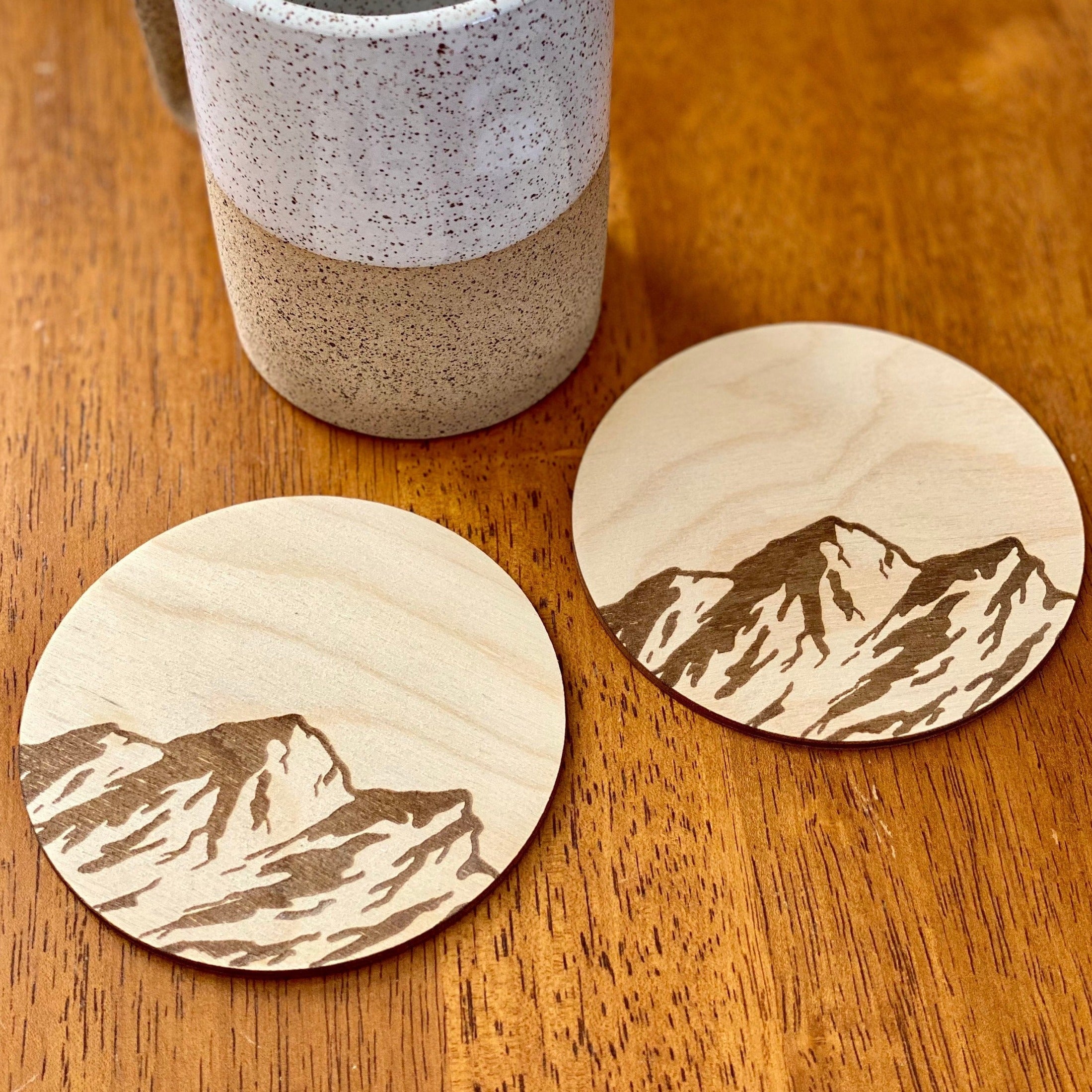 Mountain Engraved Wood Coaster Set featuring pine tree and bird designs, made from high-quality Baltic Birch.