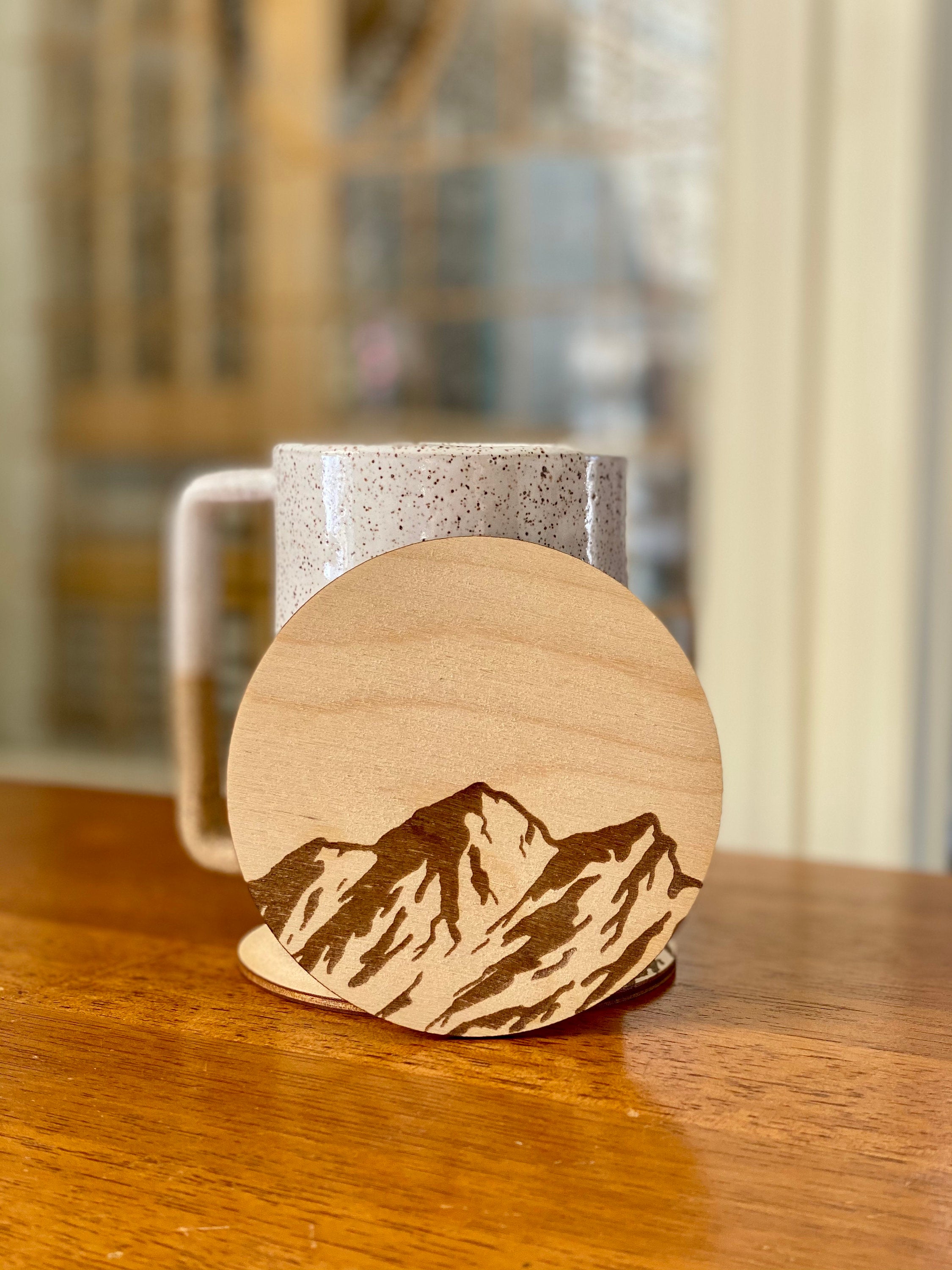 Mountain Engraved Wood Coaster Set featuring pine tree and bird designs, made from high-quality Baltic Birch.