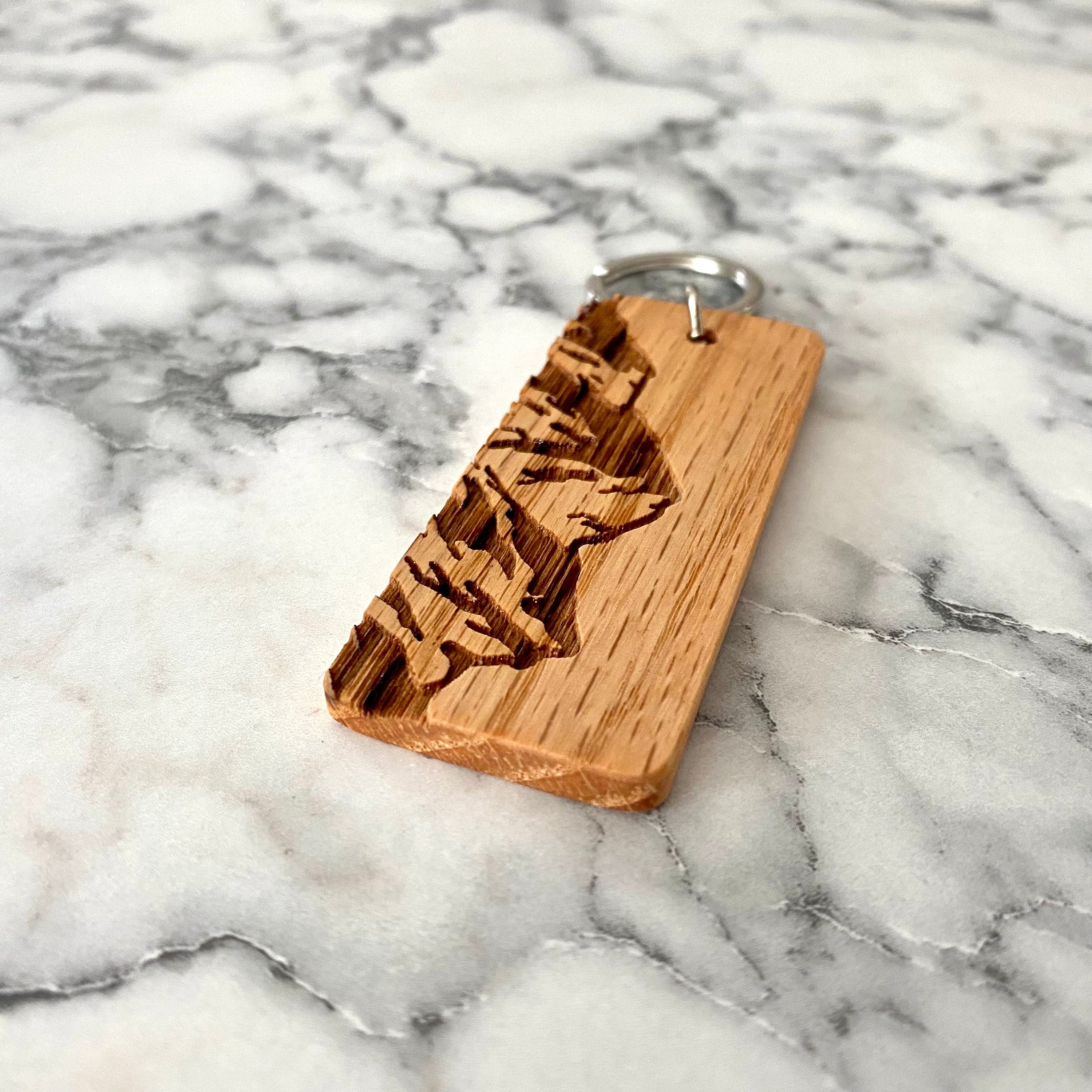 Mountain Engraved Wood Keychain made from solid oak with a laser-engraved mountain range design.