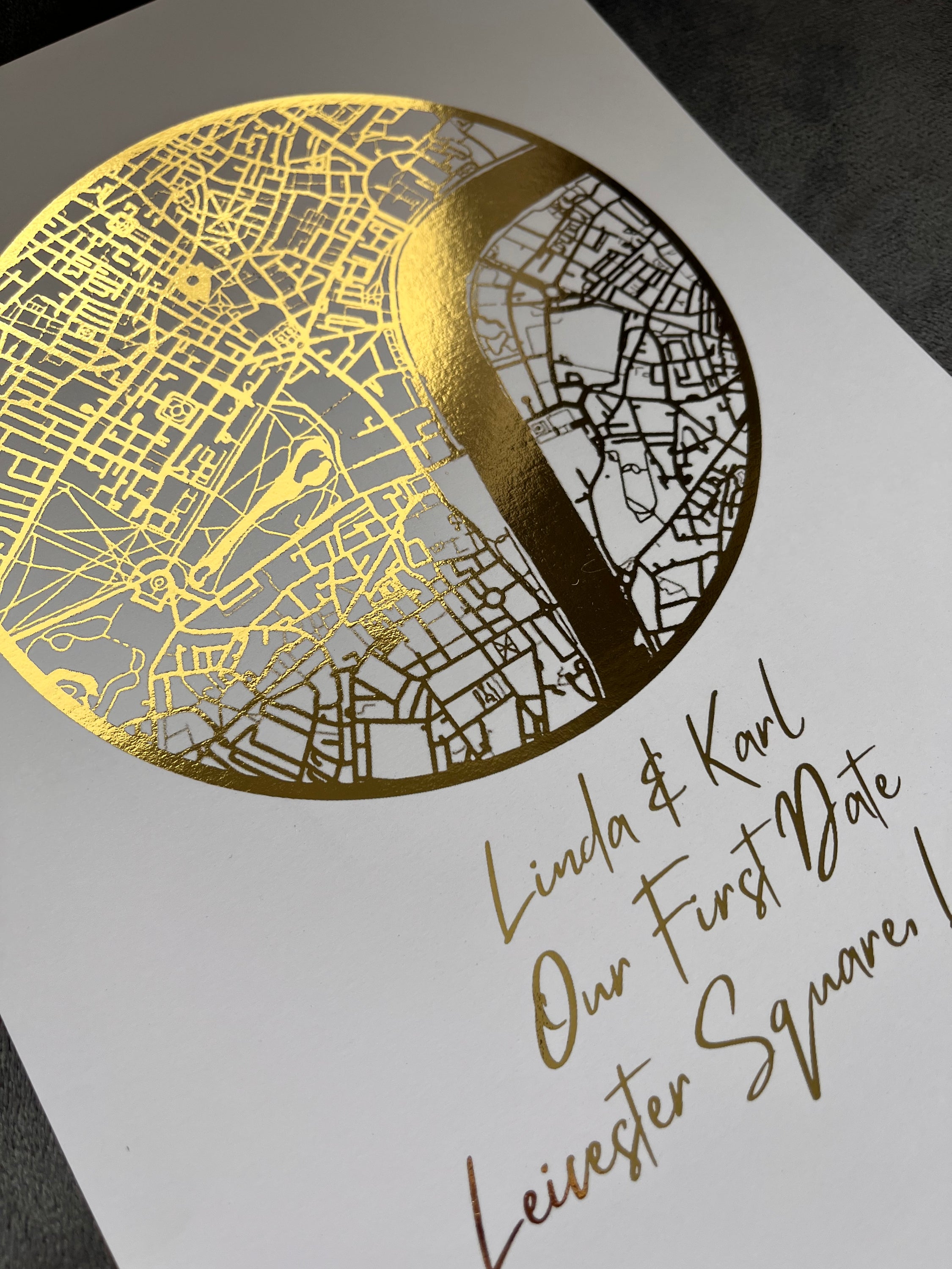 A beautifully crafted gold foil printed map in a circle shape, personalized with names and a location, symbolizing a couple's first date.