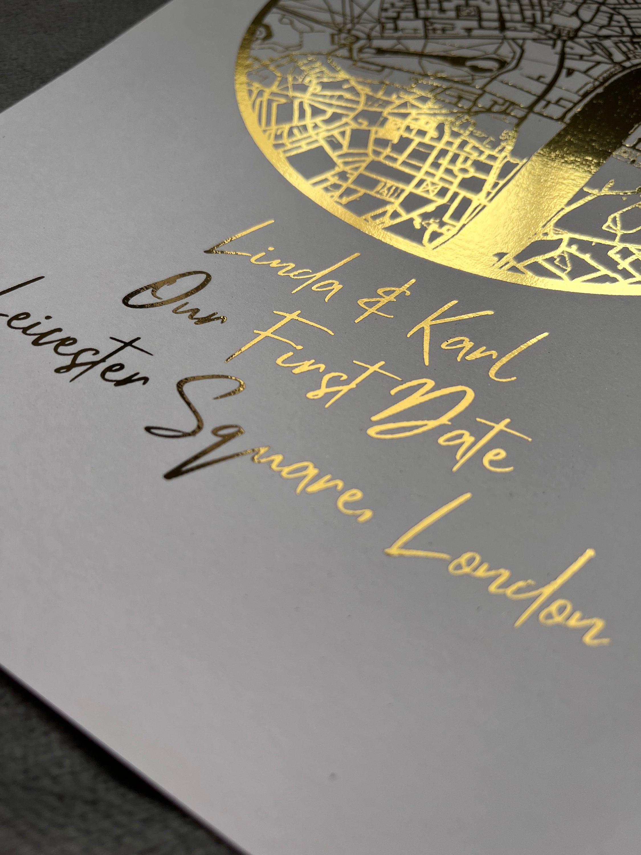 A beautifully crafted gold foil printed map in a circle shape, personalized with names and a location, symbolizing a couple's first date.