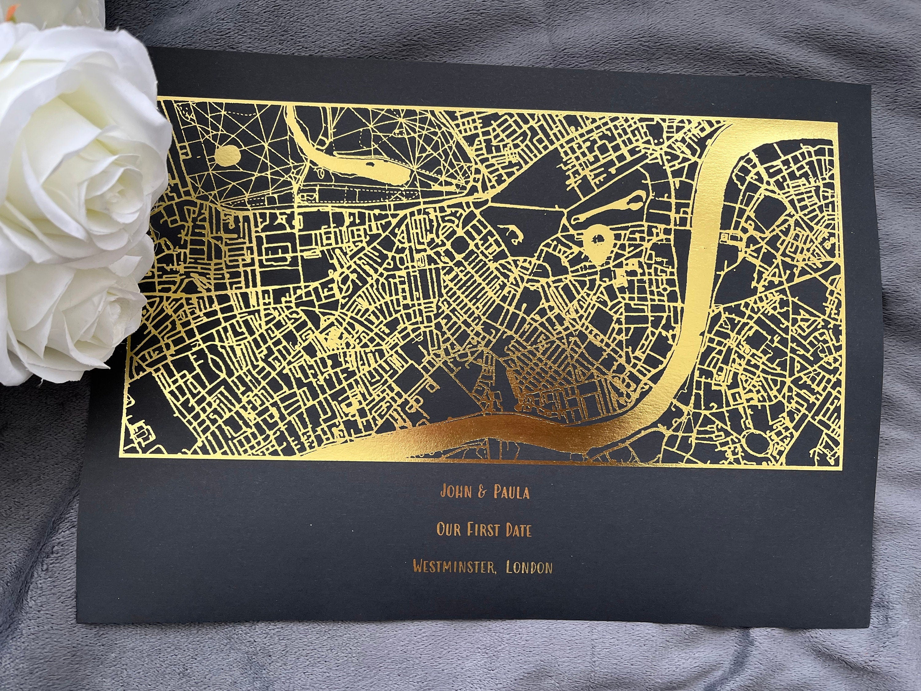 A beautifully designed foil printed map highlighting a couple's first date location, featuring elegant foil accents in various colors.