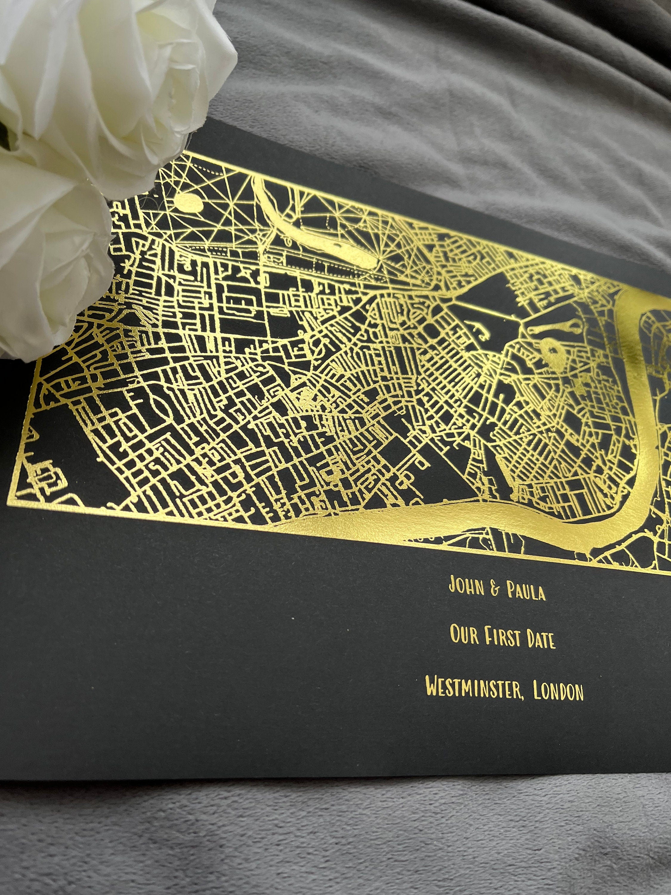 A beautifully designed foil printed map highlighting a couple's first date location, featuring elegant foil accents in various colors.