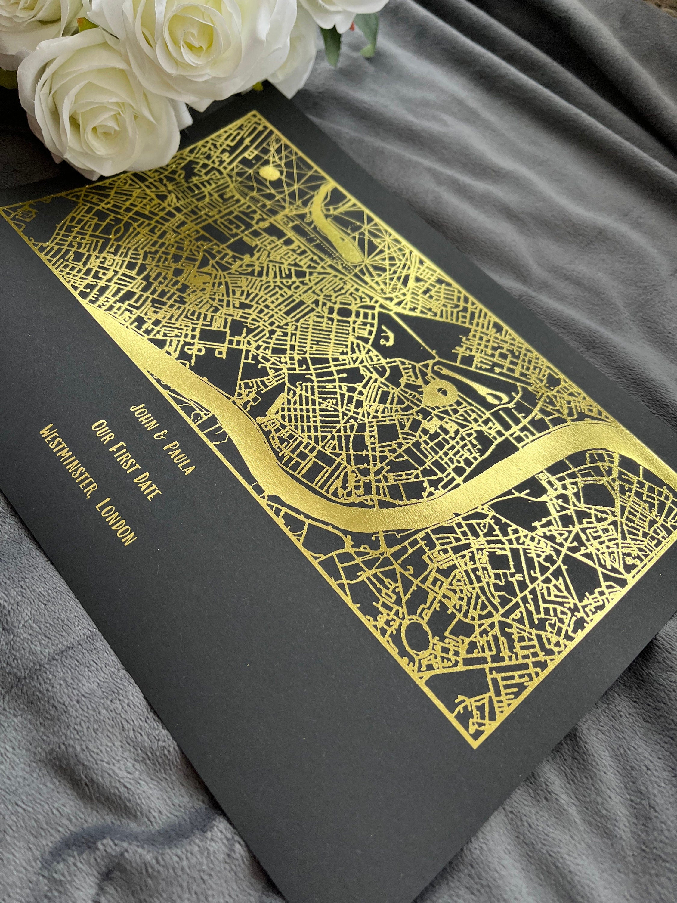 A beautifully designed foil printed map highlighting a couple's first date location, featuring elegant foil accents in various colors.