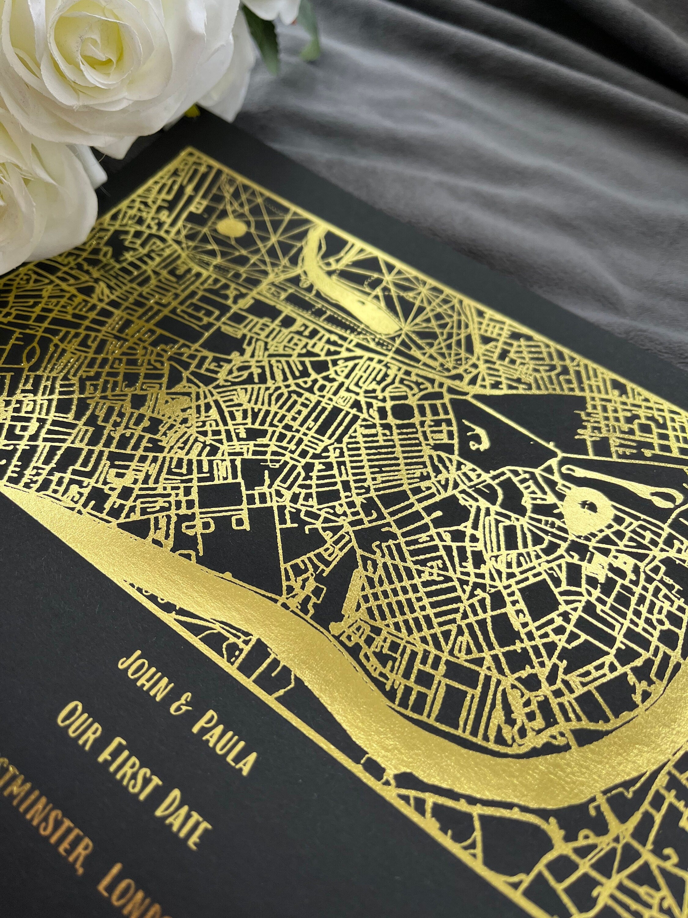 A beautifully designed foil printed map highlighting a couple's first date location, featuring elegant foil accents in various colors.