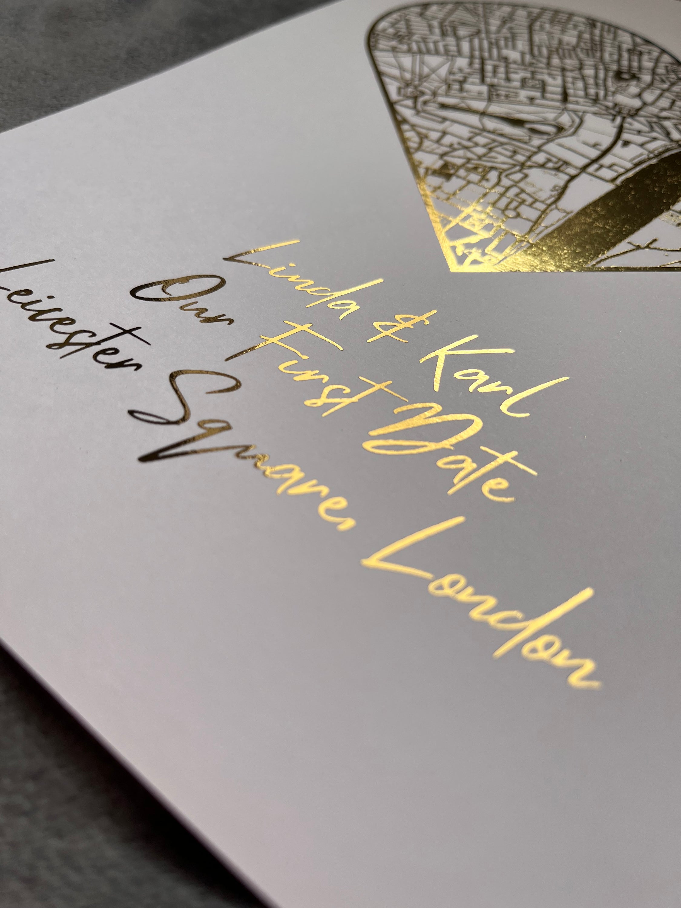 A beautifully crafted heart-shaped map featuring gold foil printing, personalized with couple's names and first date location.