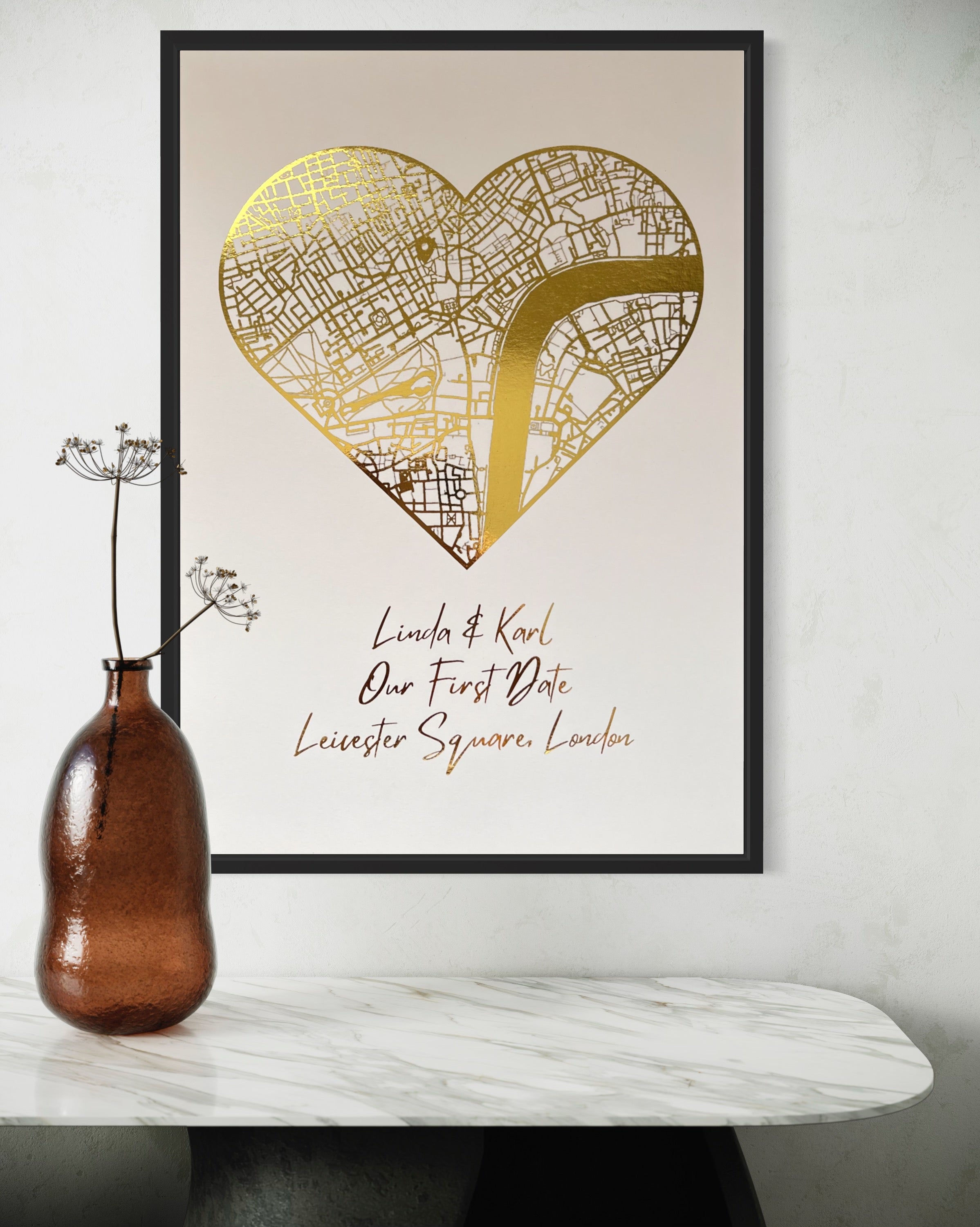 A beautifully crafted heart-shaped map featuring gold foil printing, personalized with couple's names and first date location.