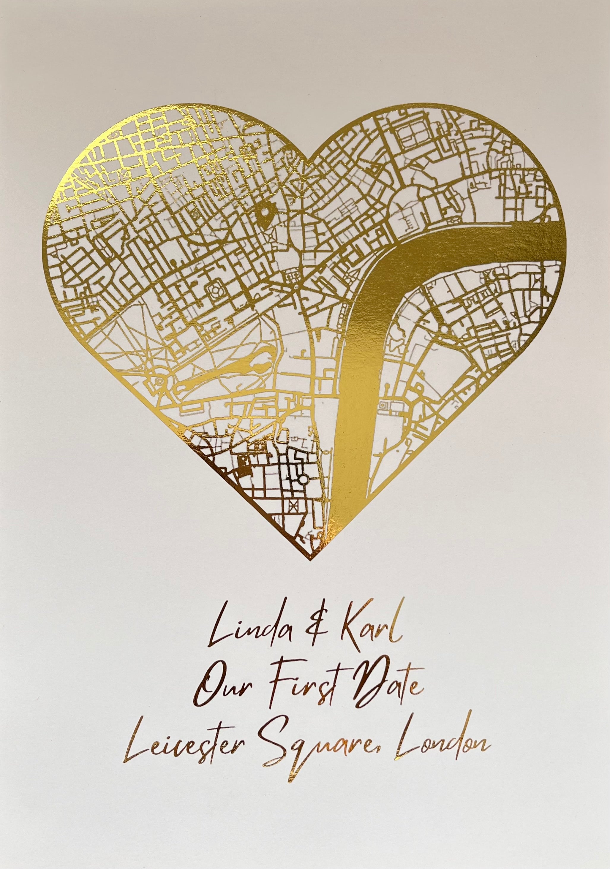 A beautifully crafted heart-shaped map featuring gold foil printing, personalized with couple's names and first date location.