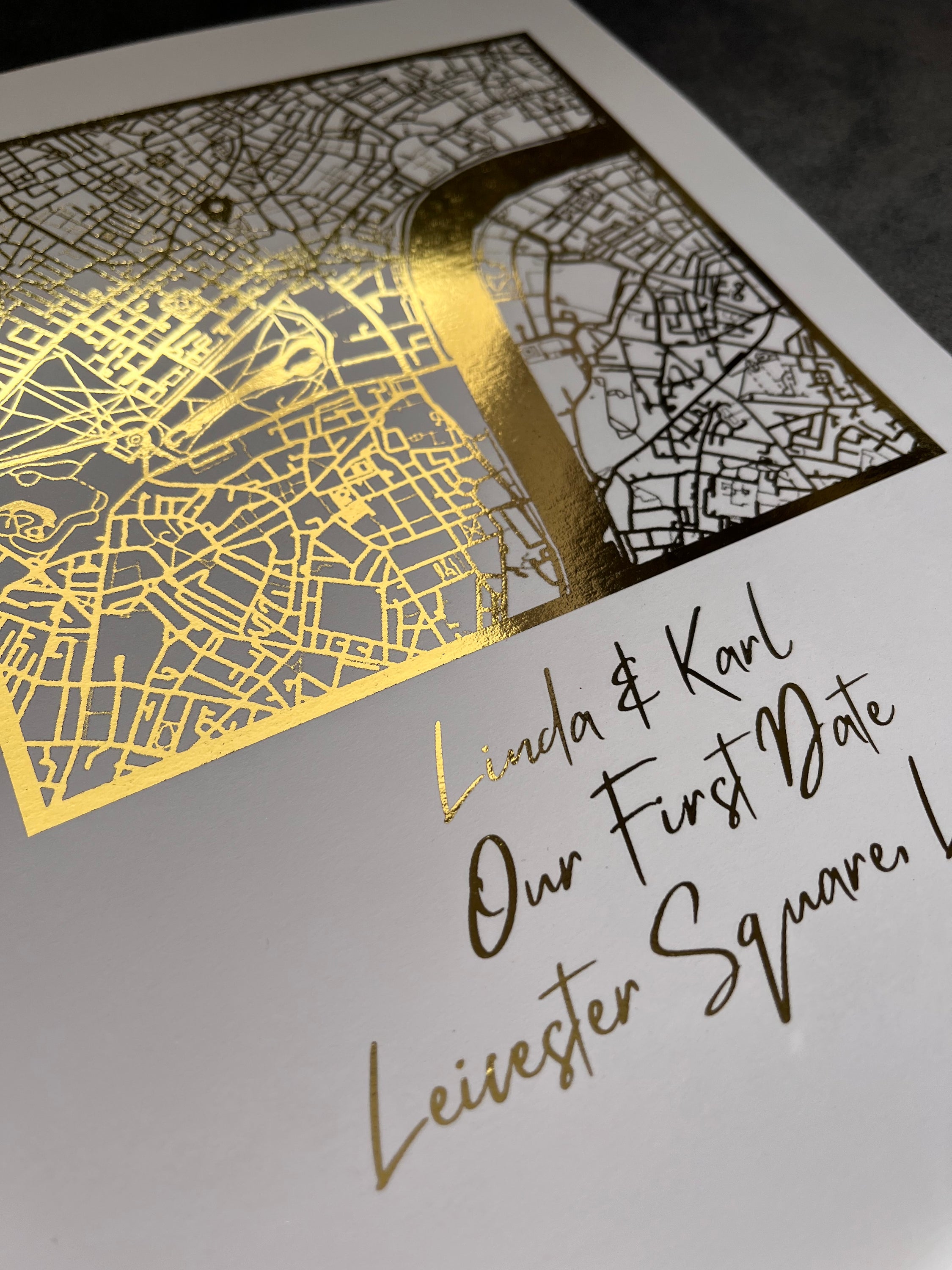 A beautifully crafted square map featuring gold foil accents, personalized with couple's names and first date location.