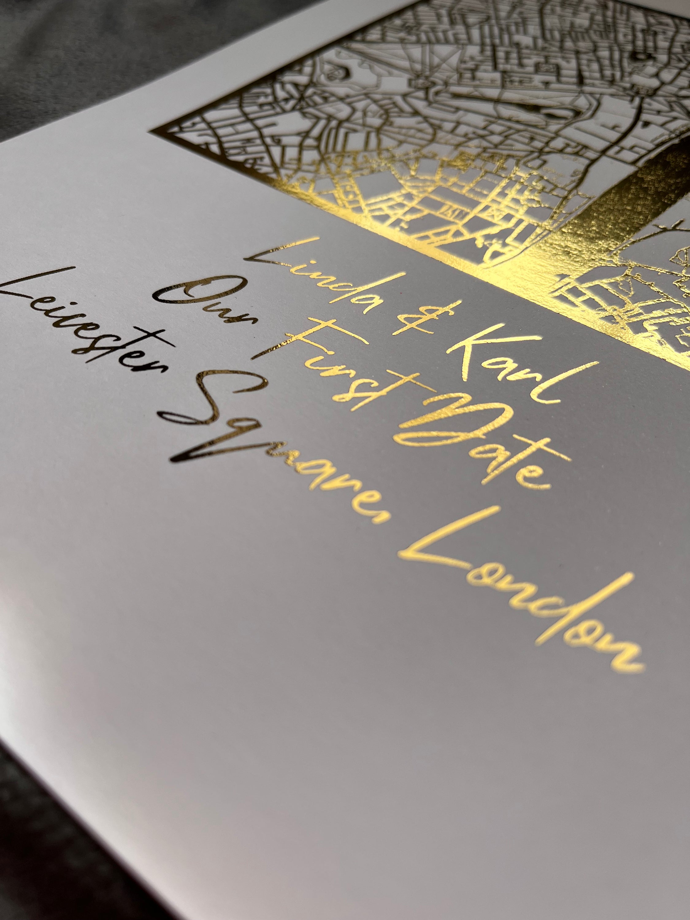 A beautifully crafted square map featuring gold foil accents, personalized with couple's names and first date location.