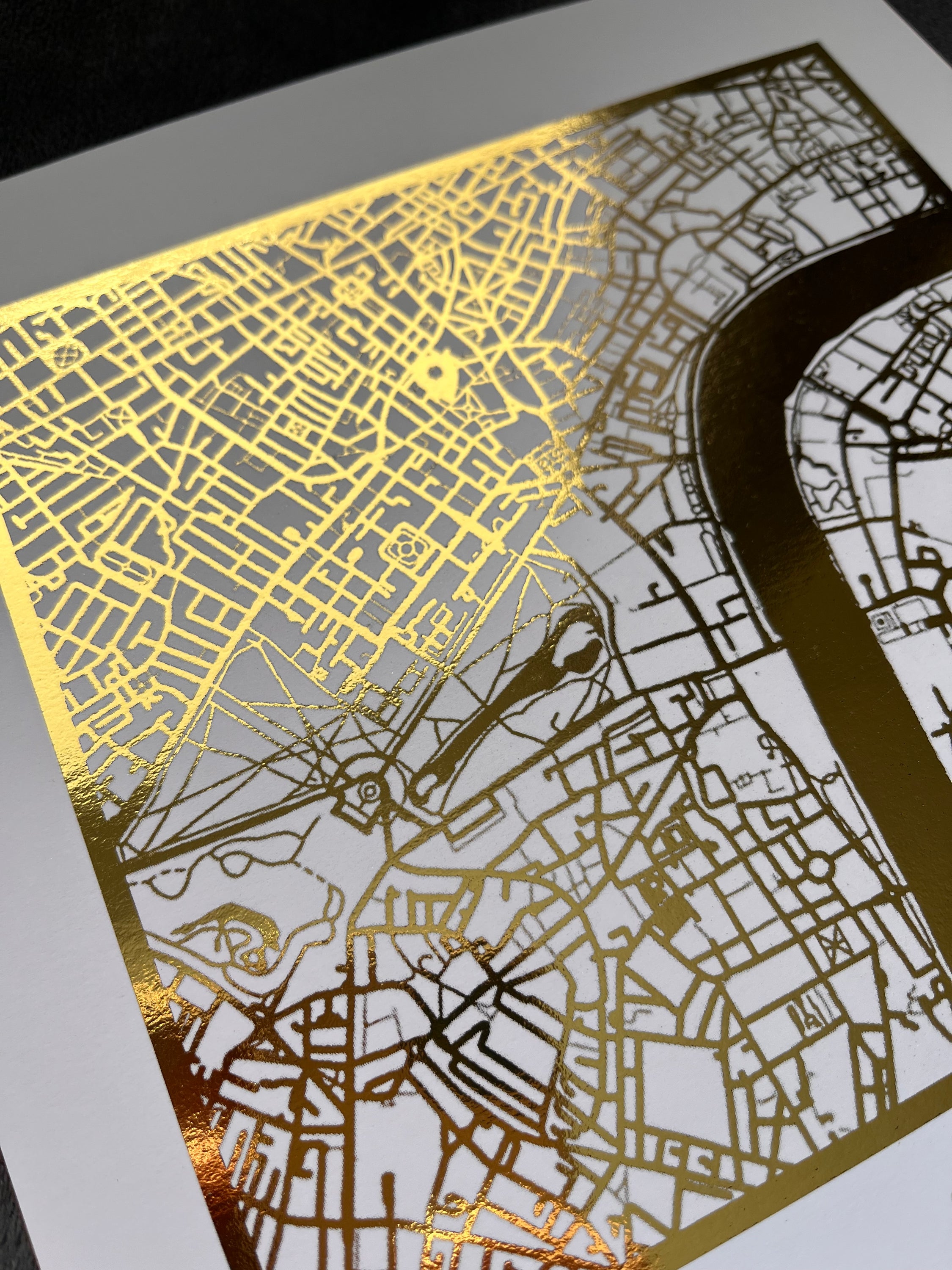 A beautifully crafted square map featuring gold foil accents, personalized with couple's names and first date location.