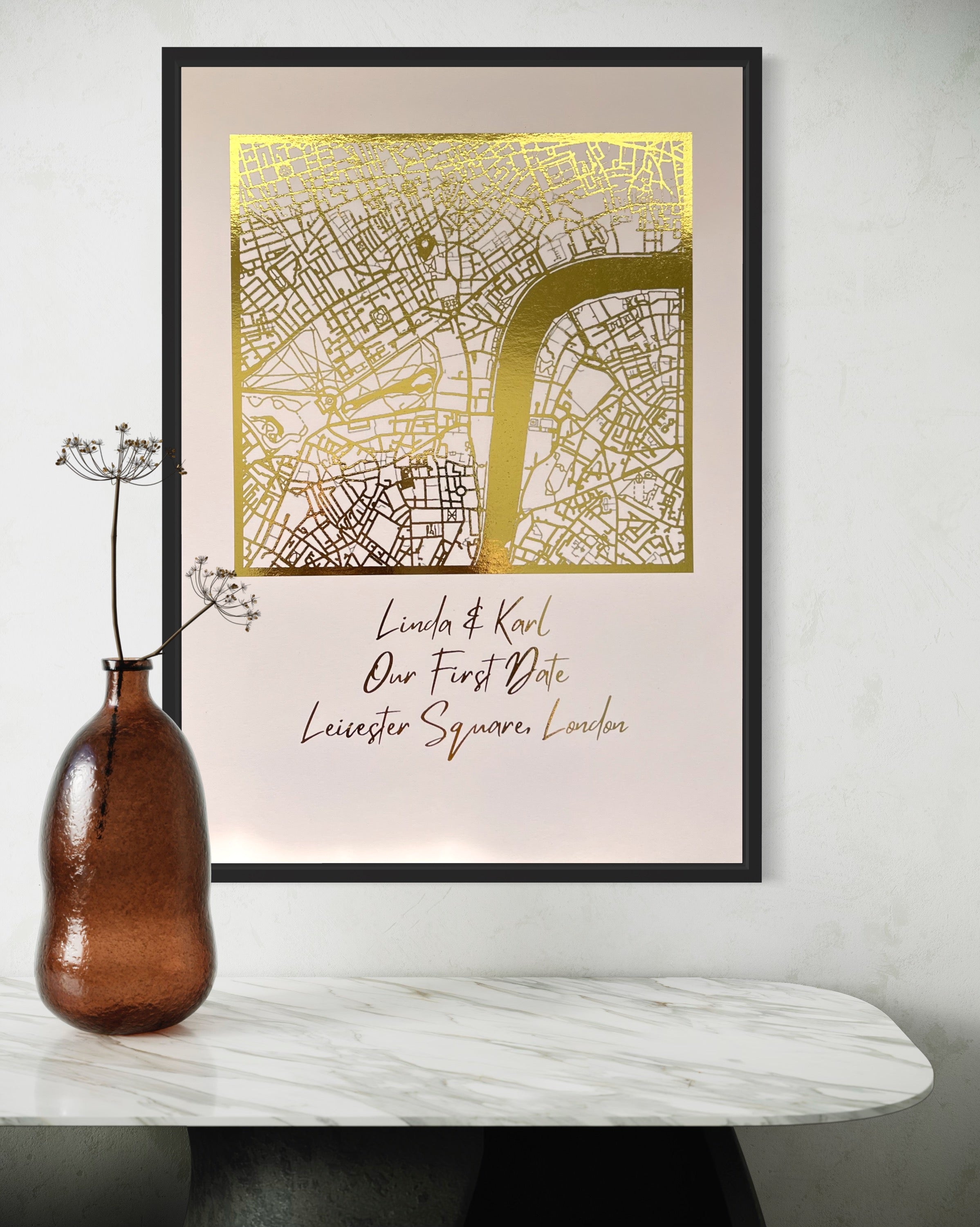 A beautifully crafted square map featuring gold foil accents, personalized with couple's names and first date location.