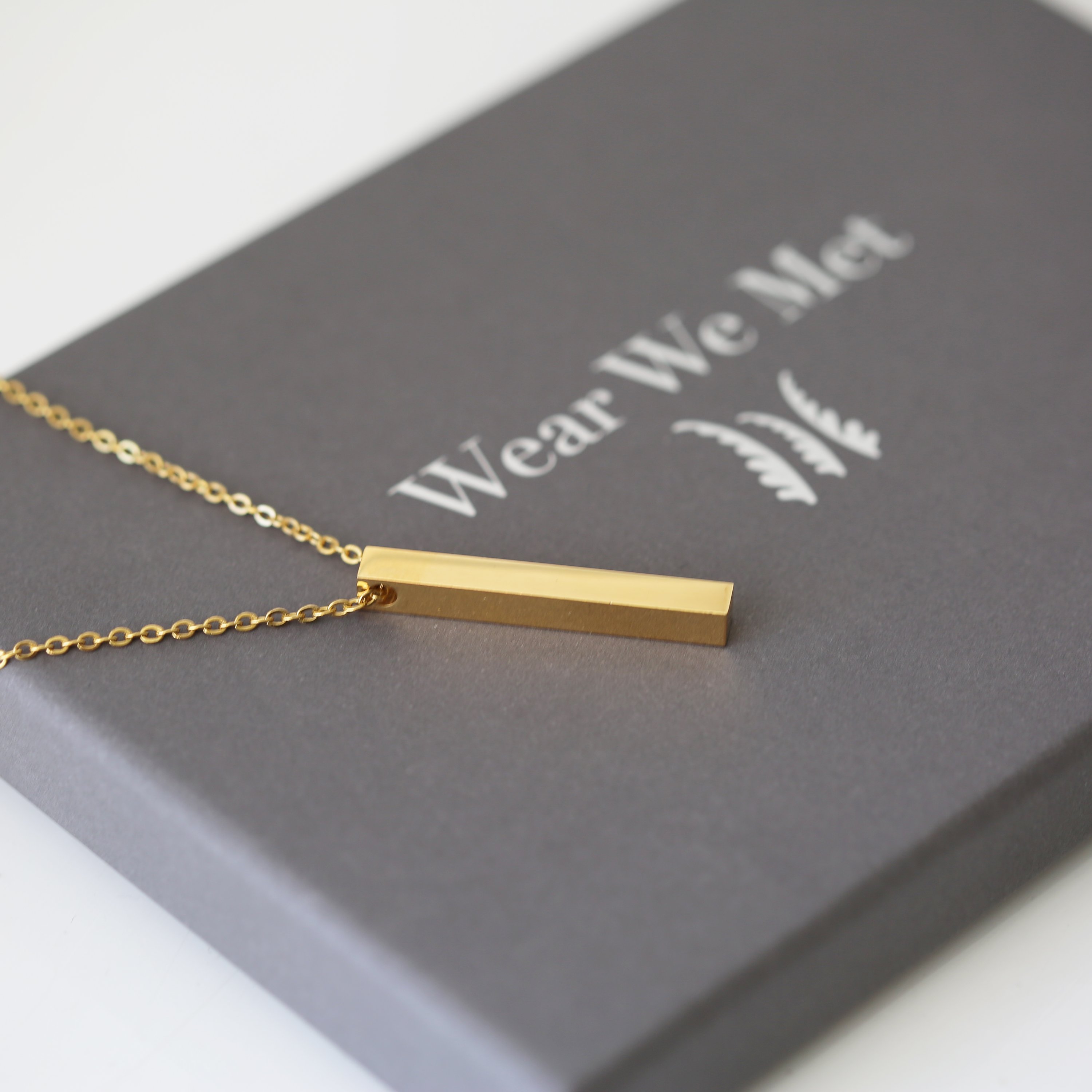 A modern personalised bar necklace available in silver, gold, and rose gold, elegantly engraved with a custom message.