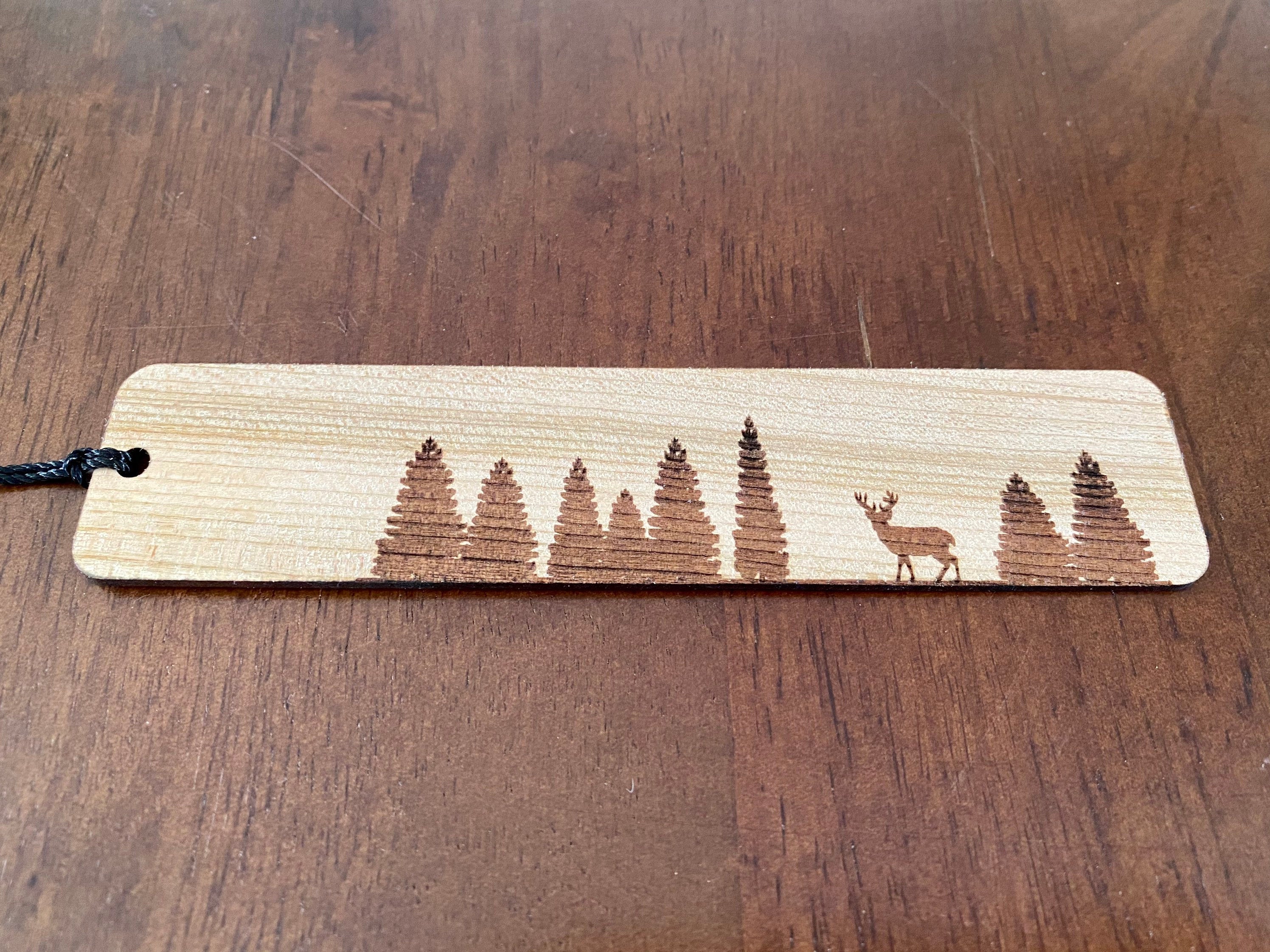 Pine Tree & Deer Engraved Wood Bookmark made from Cherry hardwood with a tassel.