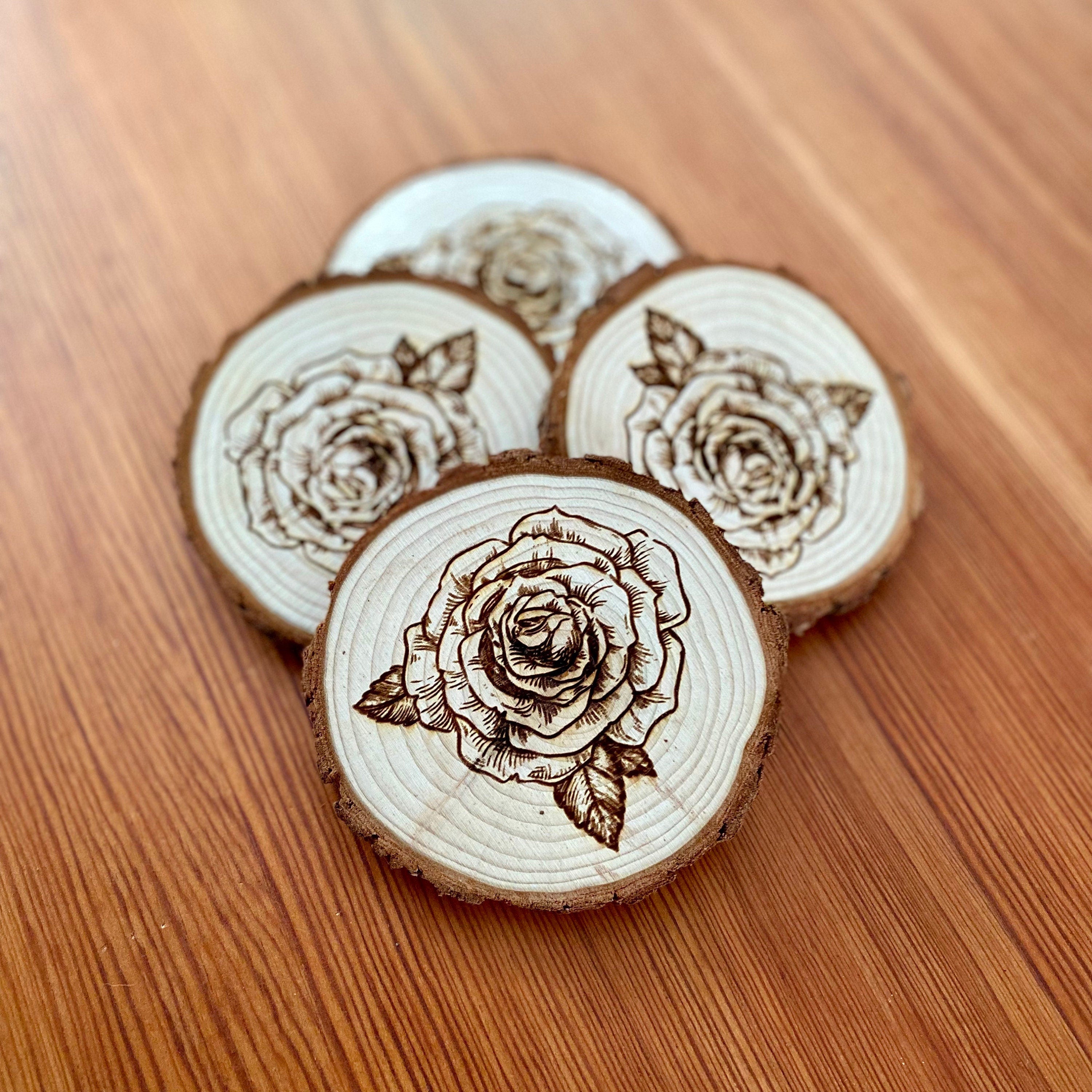 A set of four rose engraved wood coasters, showcasing intricate rose designs on a natural wood surface, ideal for home decor.