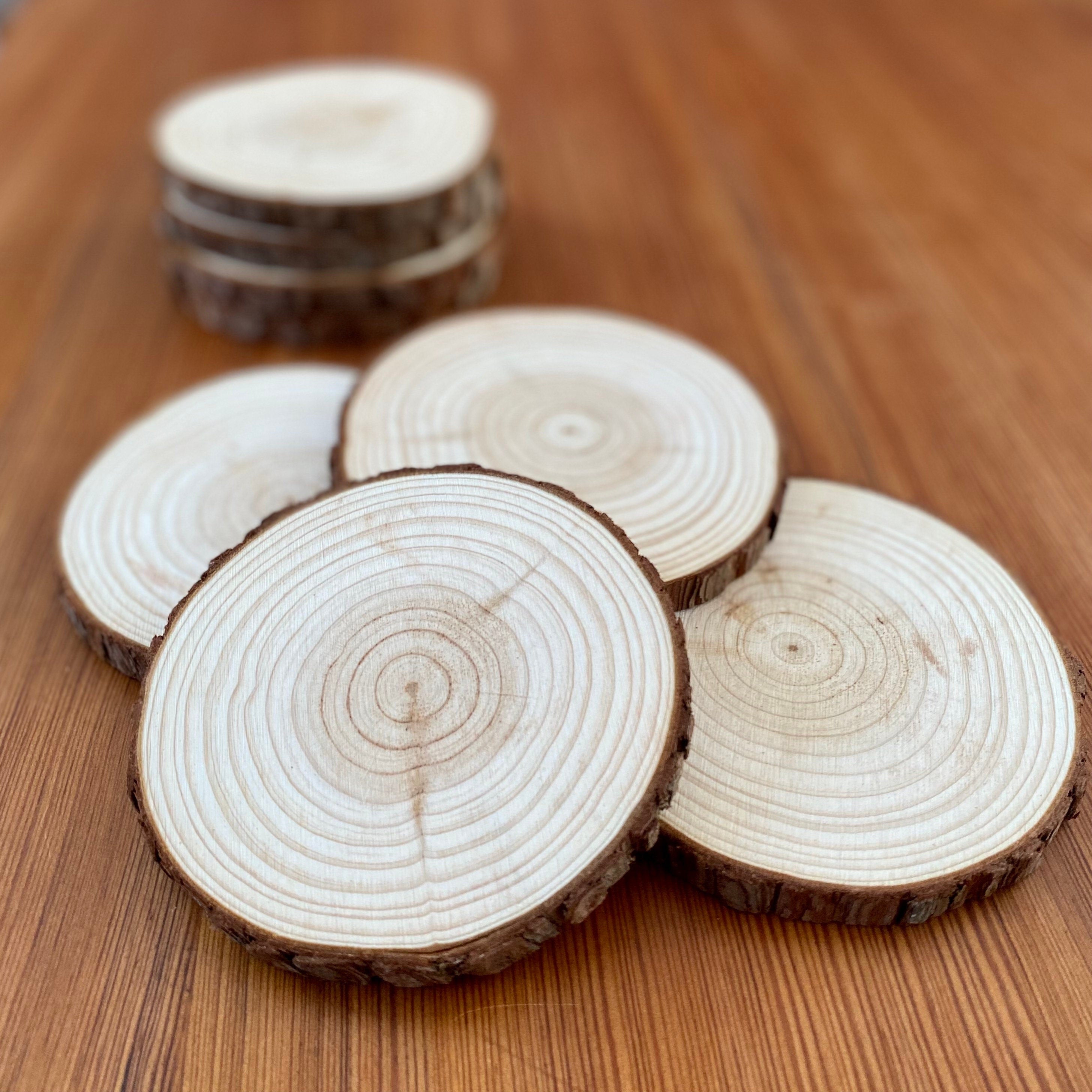 A set of rustic wood slice coasters made from Californian Pine, showcasing their natural grain and smooth finish.