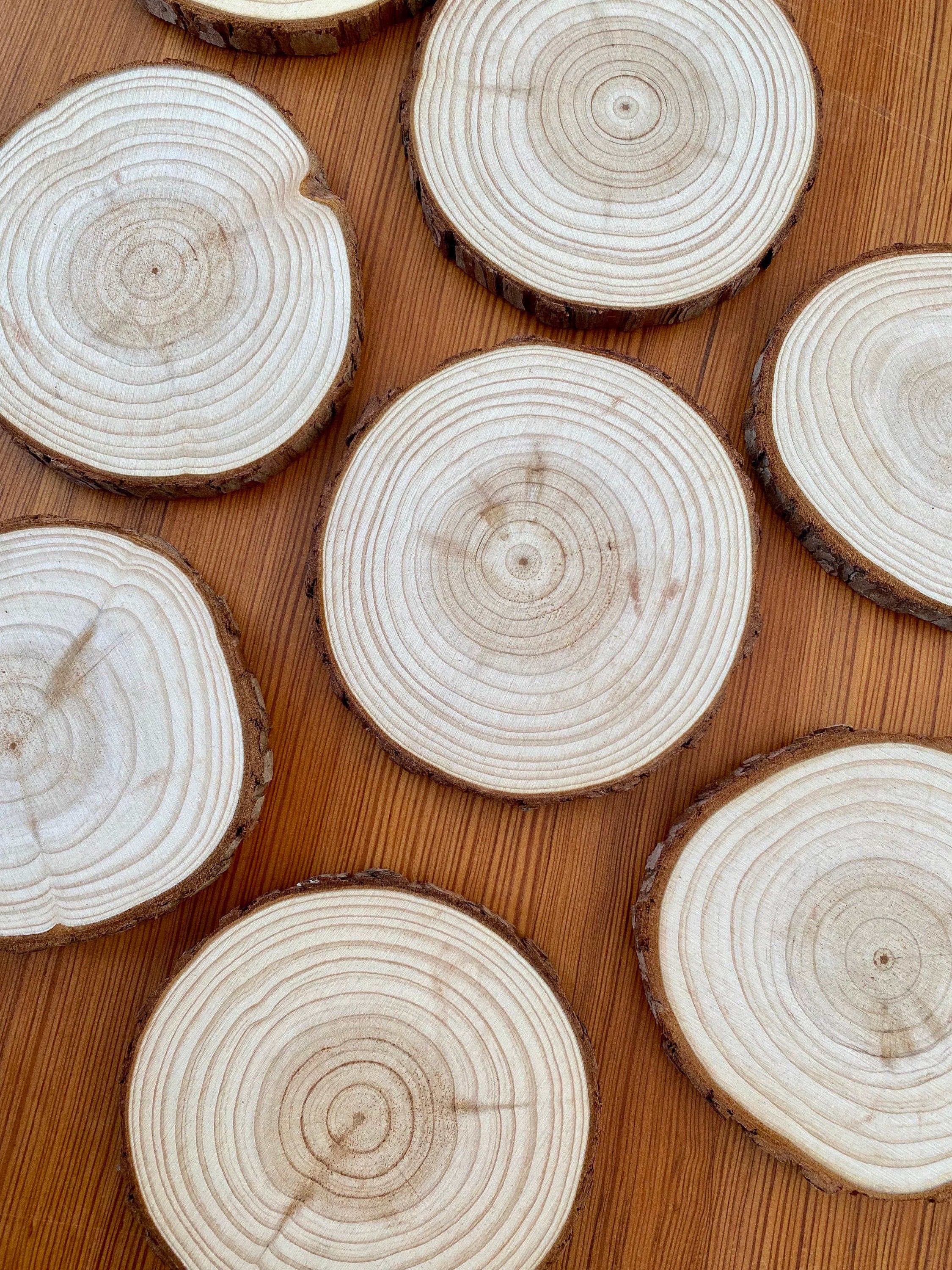 A set of rustic wood slice coasters made from Californian Pine, showcasing their natural grain and smooth finish.