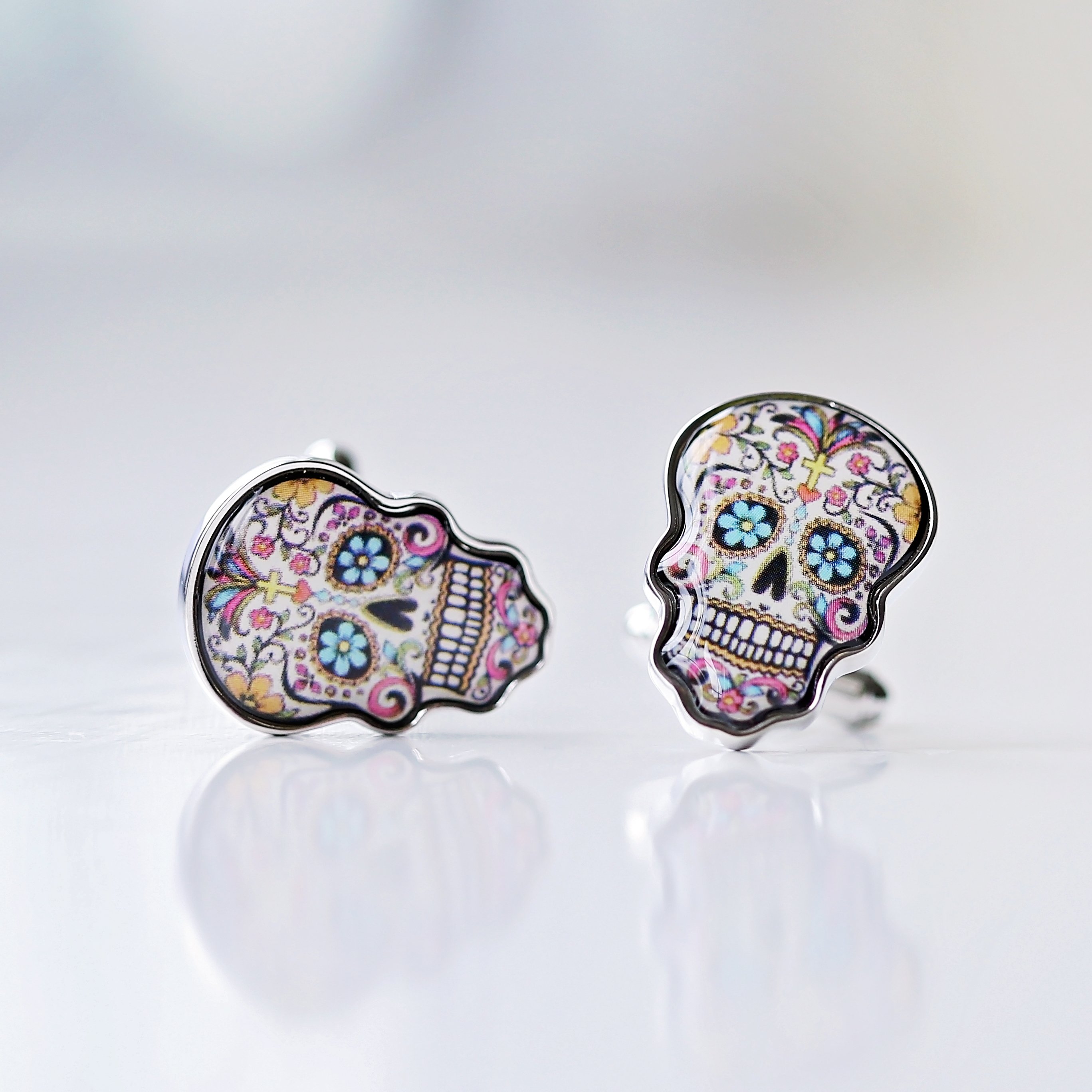 A pair of stylish skull cufflinks displayed in a luxury engraved box, showcasing intricate details and personalization options.