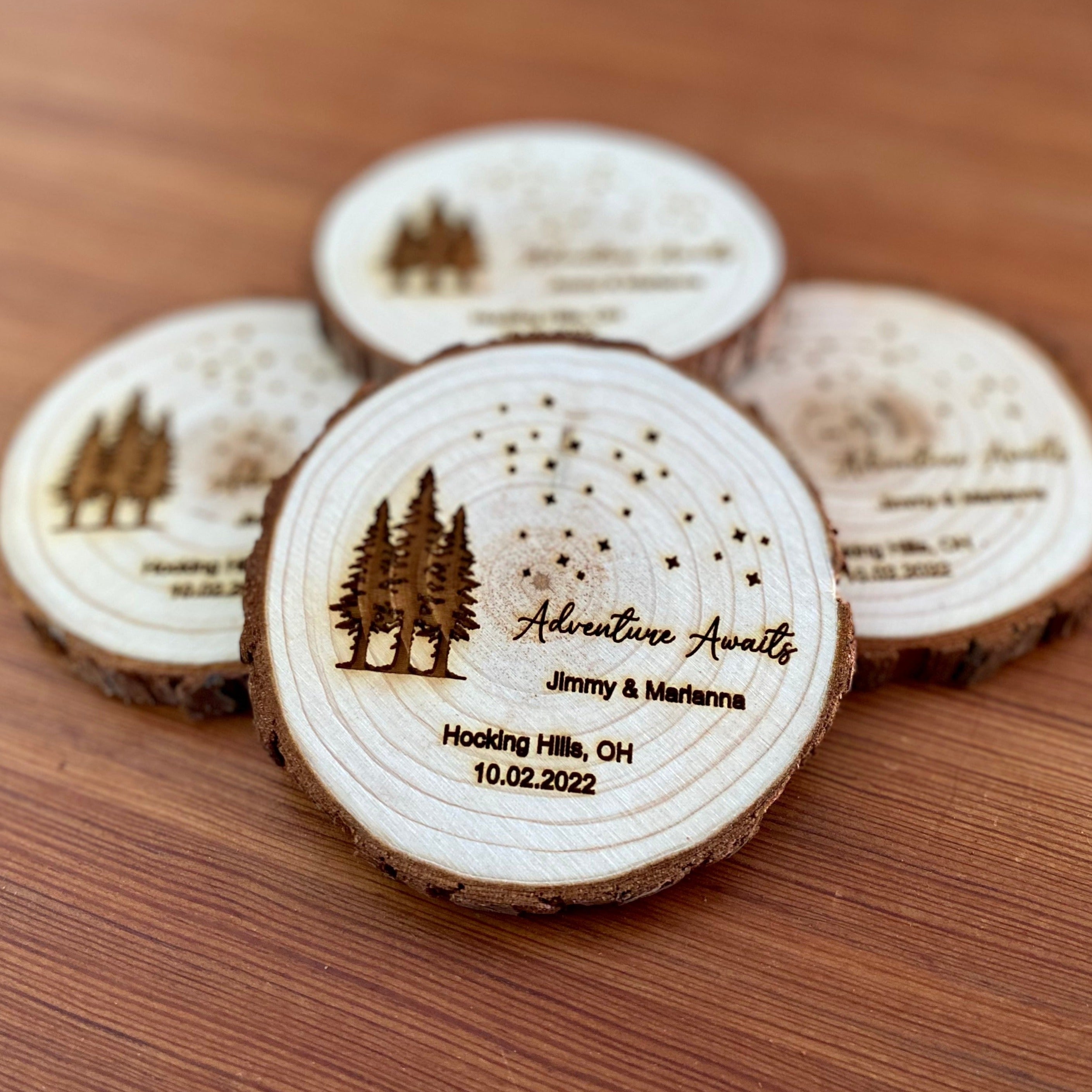 Personalized wood slice coasters with star and tree design, perfect for rustic wedding favors.