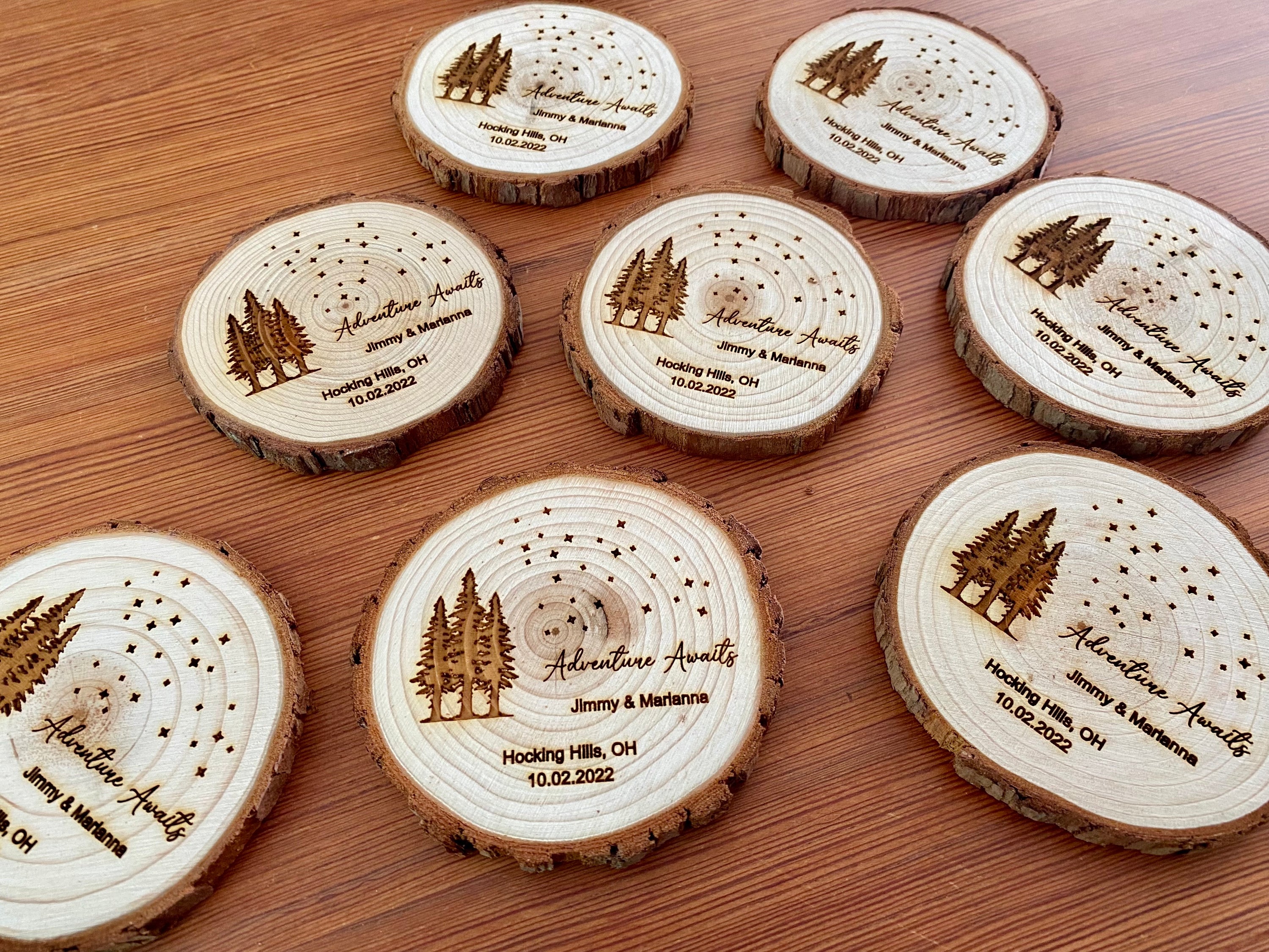 Personalized wood slice coasters with star and tree design, perfect for rustic wedding favors.