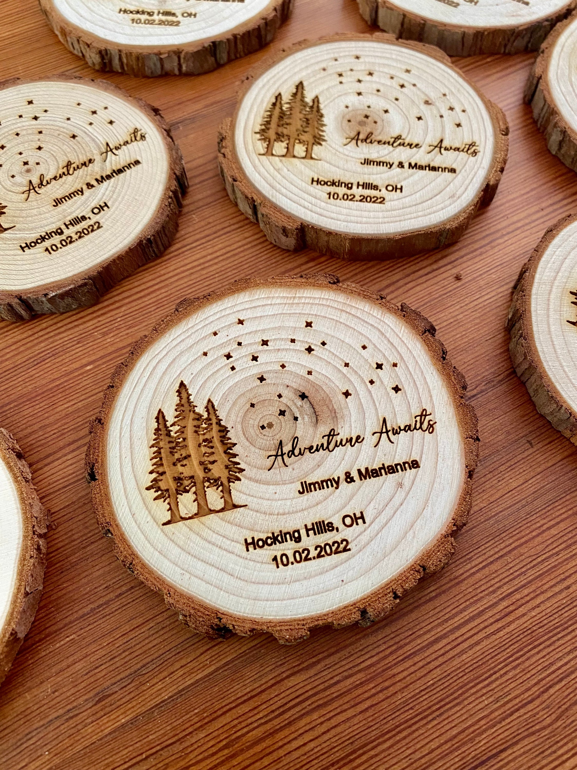 Personalized wood slice coasters with star and tree design, perfect for rustic wedding favors.