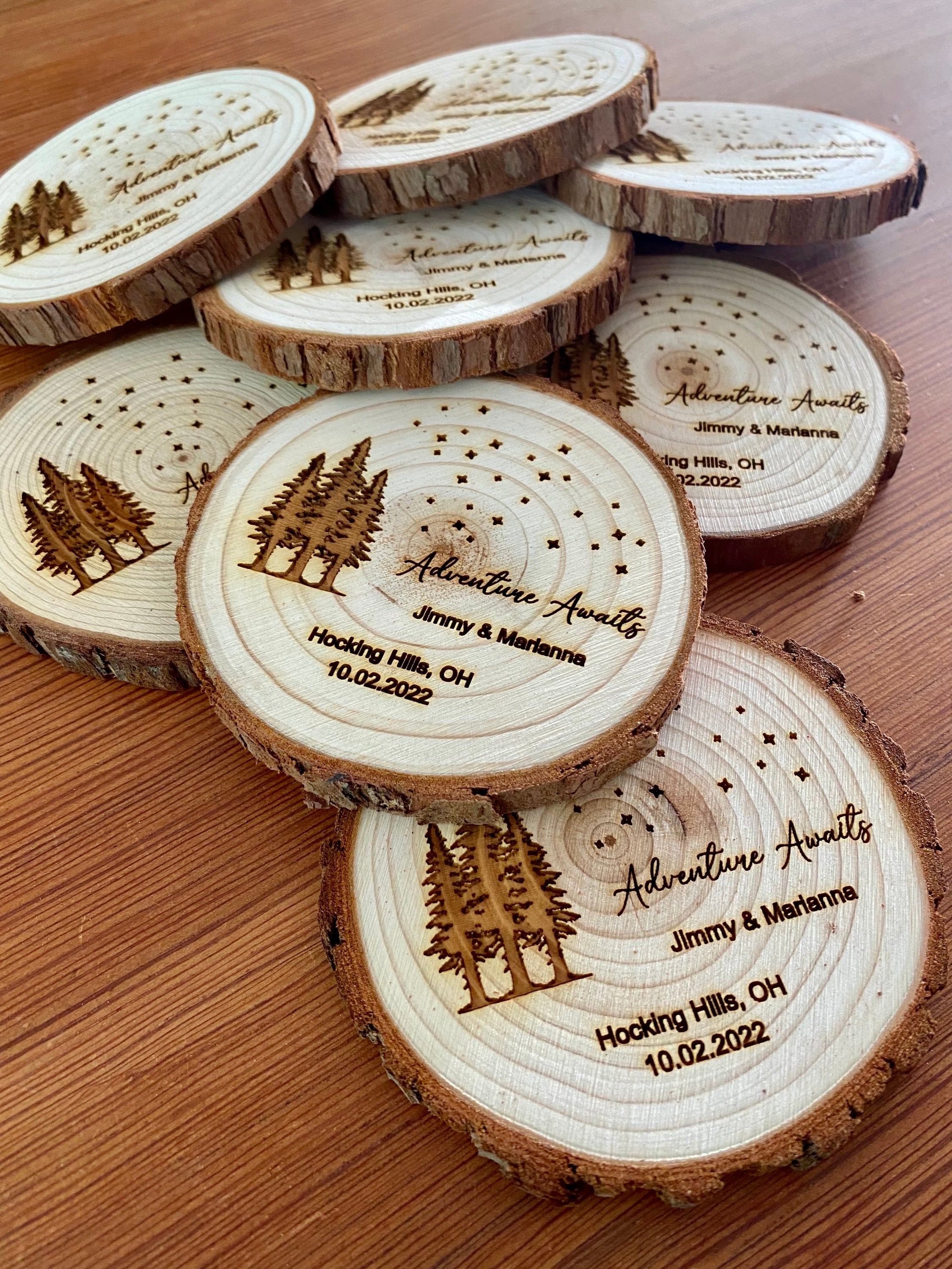 Personalized wood slice coasters with star and tree design, perfect for rustic wedding favors.