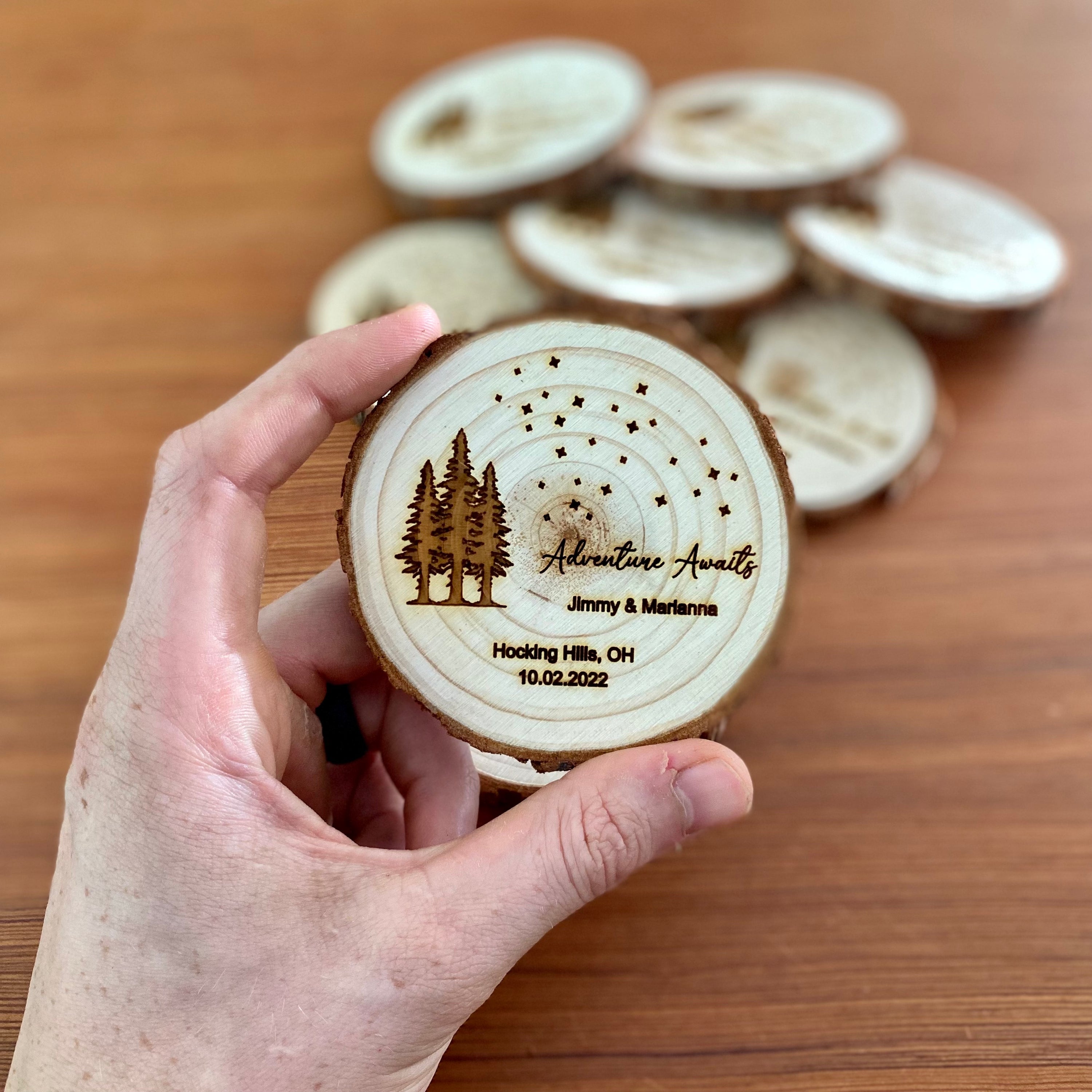 Personalized wood slice coasters with star and tree design, perfect for rustic wedding favors.