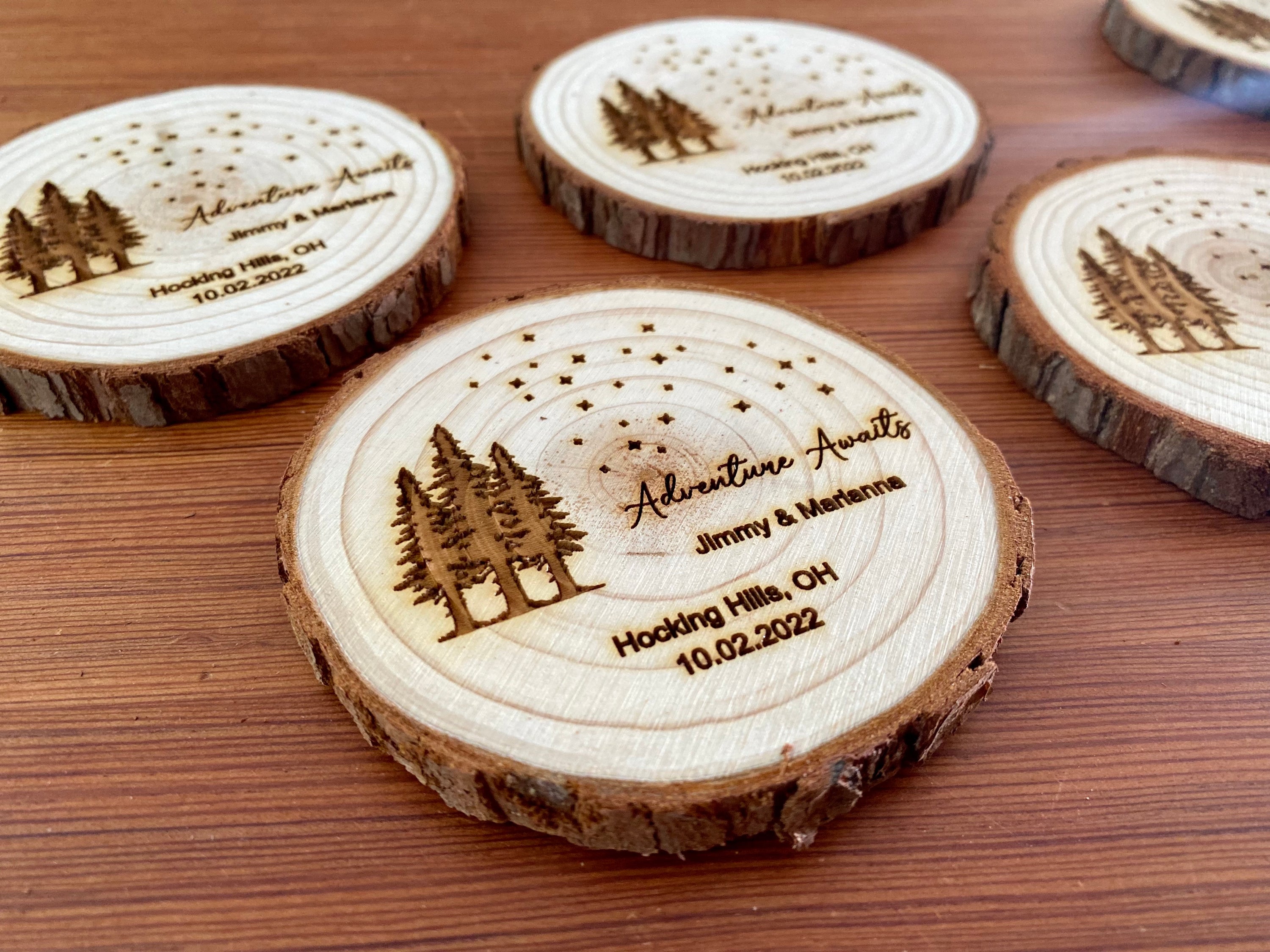 Personalized wood slice coasters with star and tree design, perfect for rustic wedding favors.