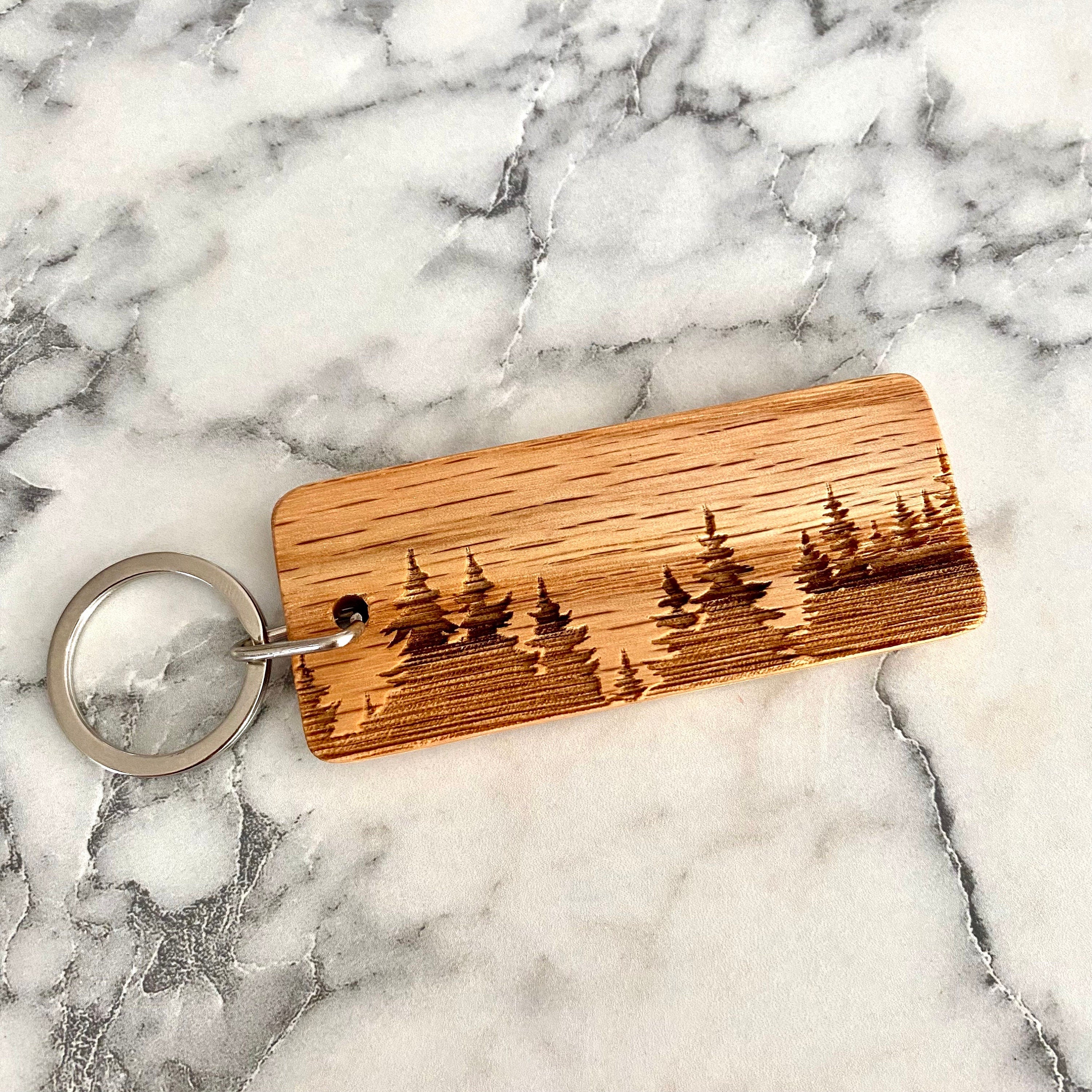 Treeline Engraved Wood Keychain featuring a laser-engraved treeline silhouette on solid oak wood.