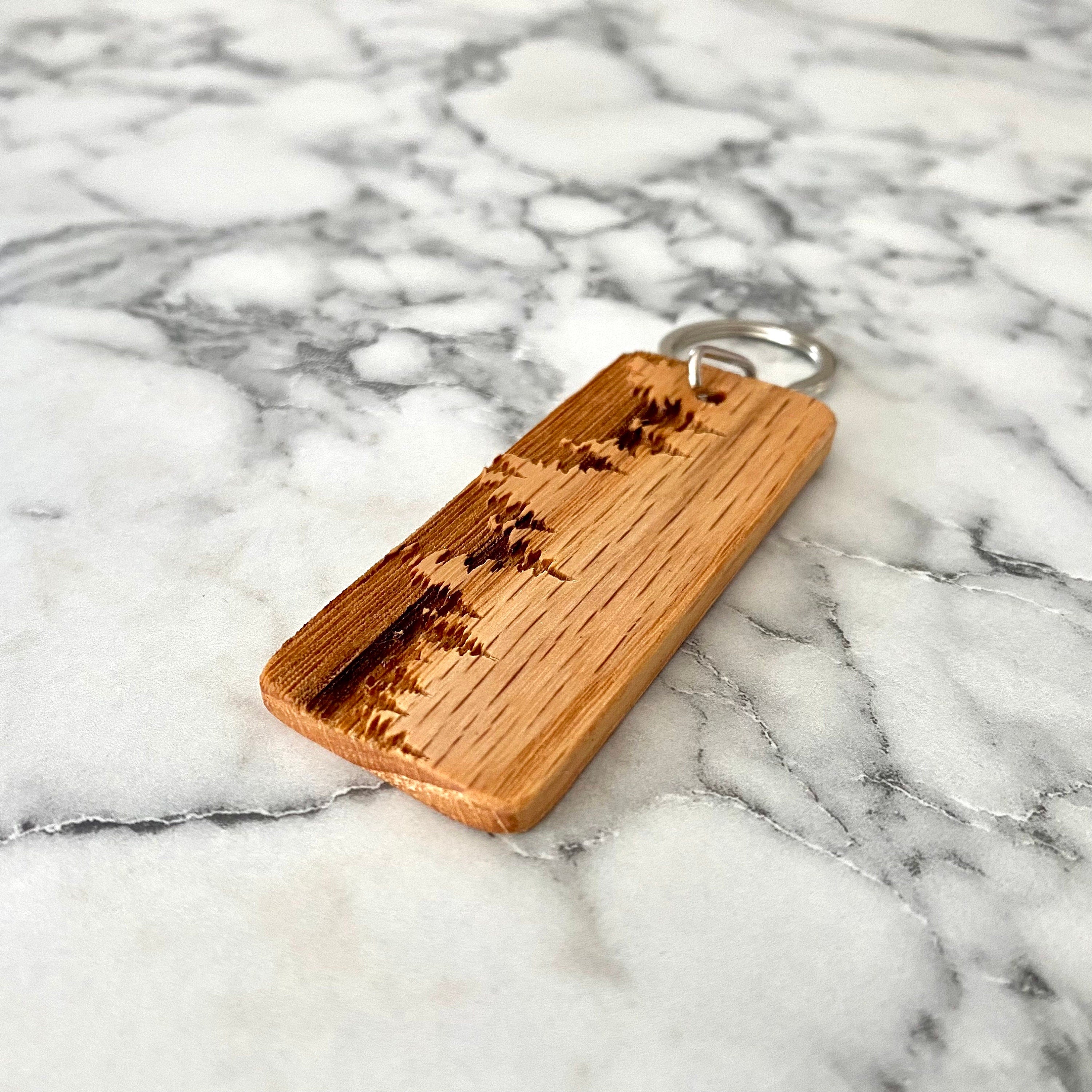 Treeline Engraved Wood Keychain featuring a laser-engraved treeline silhouette on solid oak wood.