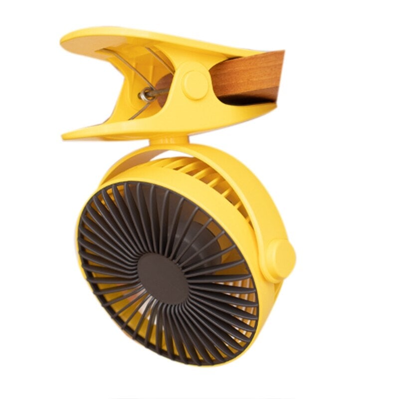 A compact USB rechargeable clip fan in yellow, designed for desktop use, showcasing its adjustable clamp and dual functionality as a fan and atmosphere light.