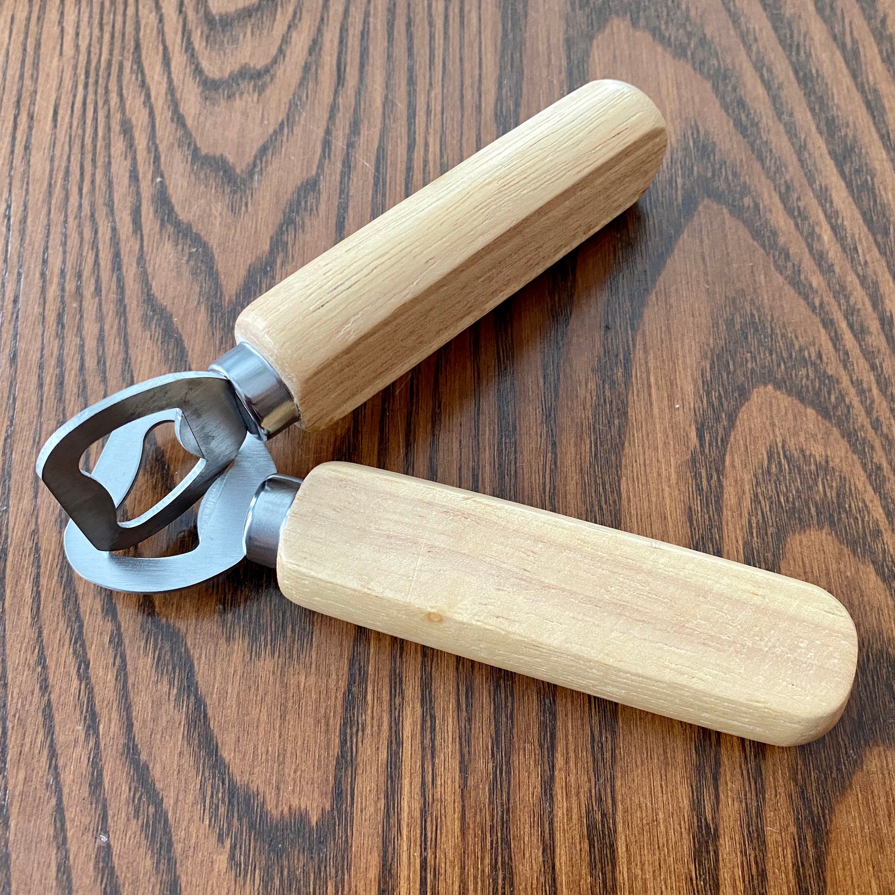 Personalized wooden bottle opener with engraved names and heart design, perfect for rustic wedding favors.