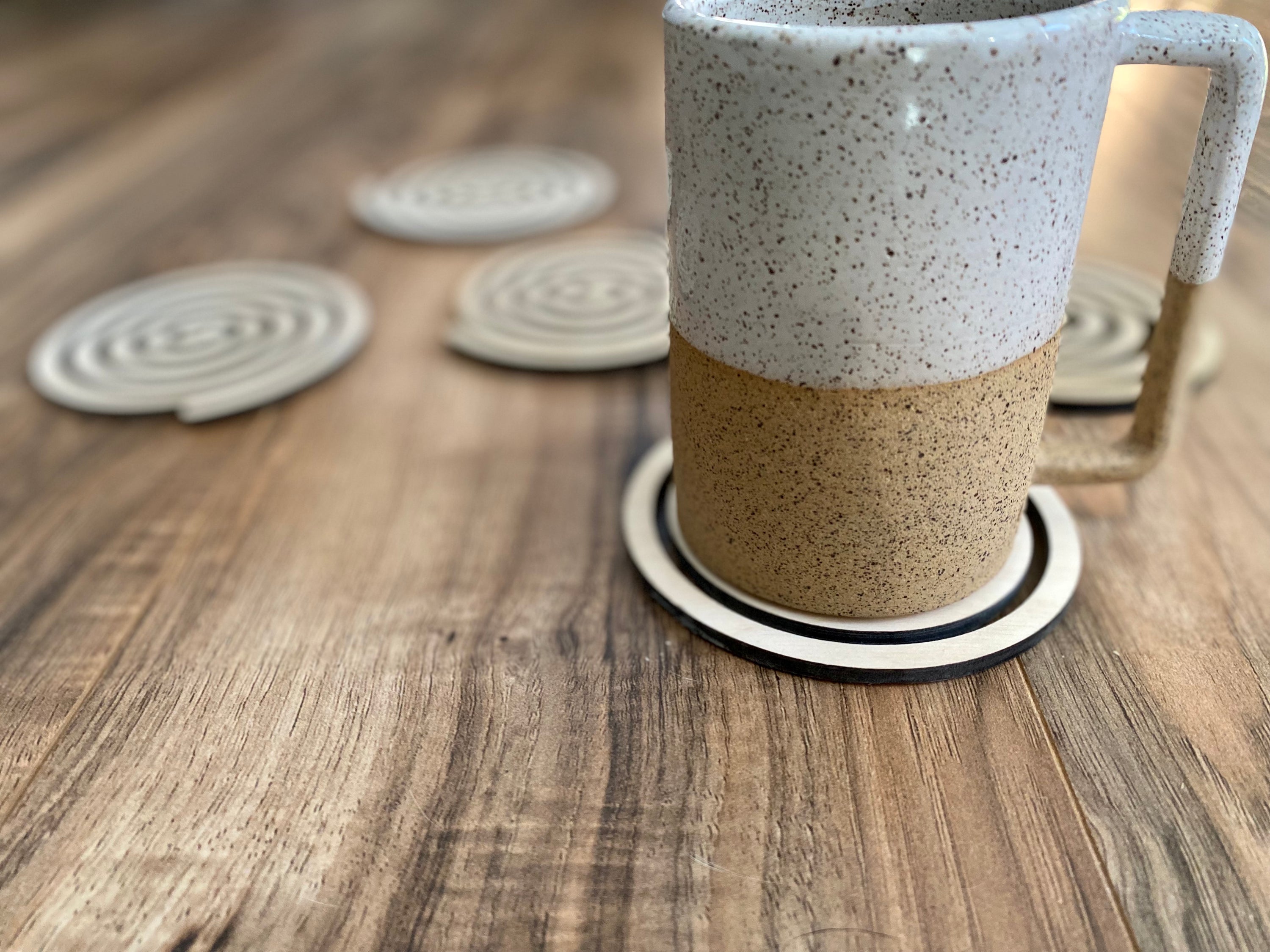 Set of unique wood spiral coasters made from high-quality birch plywood, showcasing a beautiful spiral design.