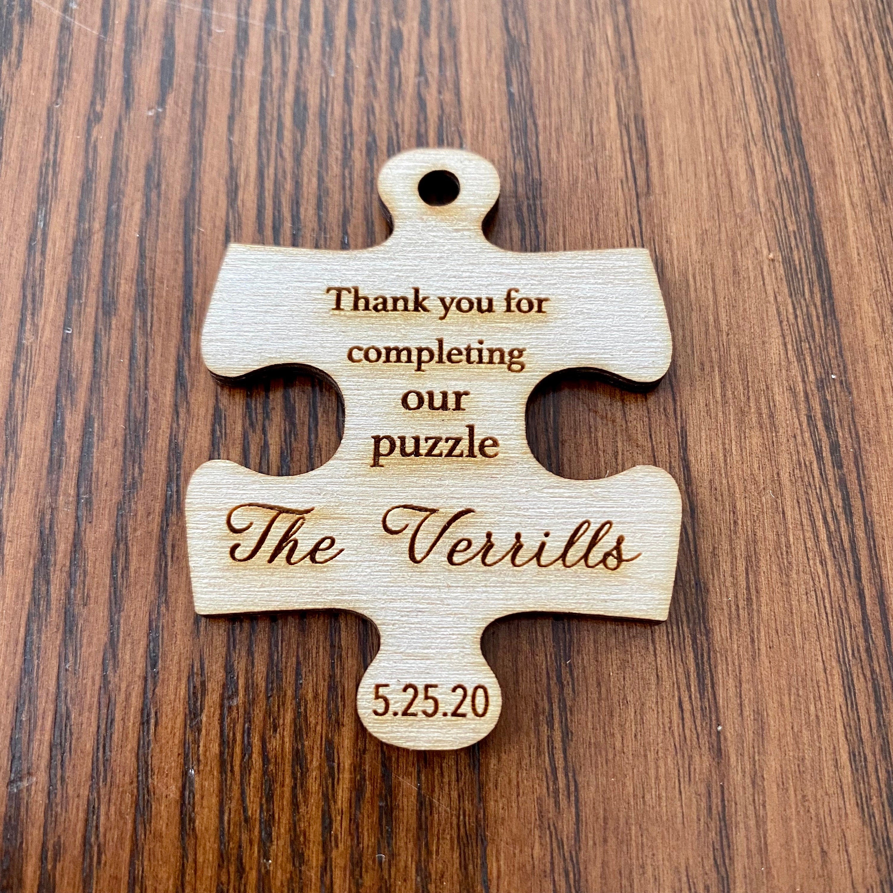 Personalized wooden puzzle piece wedding favor with engraving, showcasing rustic charm and durability.