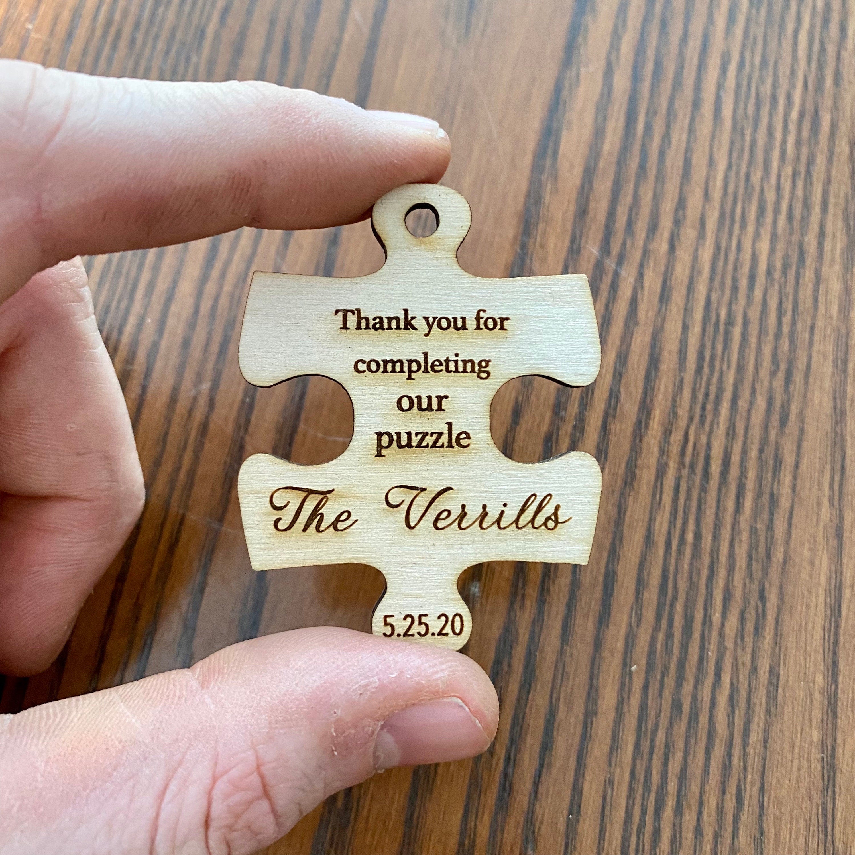 Personalized wooden puzzle piece wedding favor with engraving, showcasing rustic charm and durability.