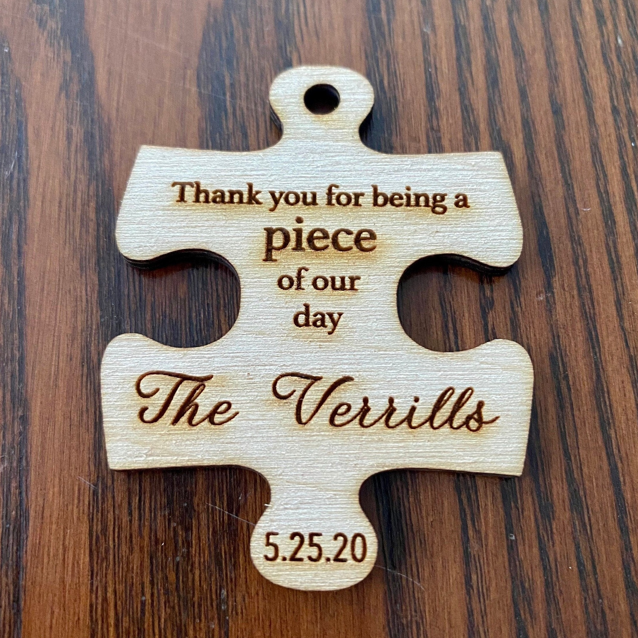 Personalized wooden puzzle piece wedding favor with custom engraving, showcasing rustic charm and durability.