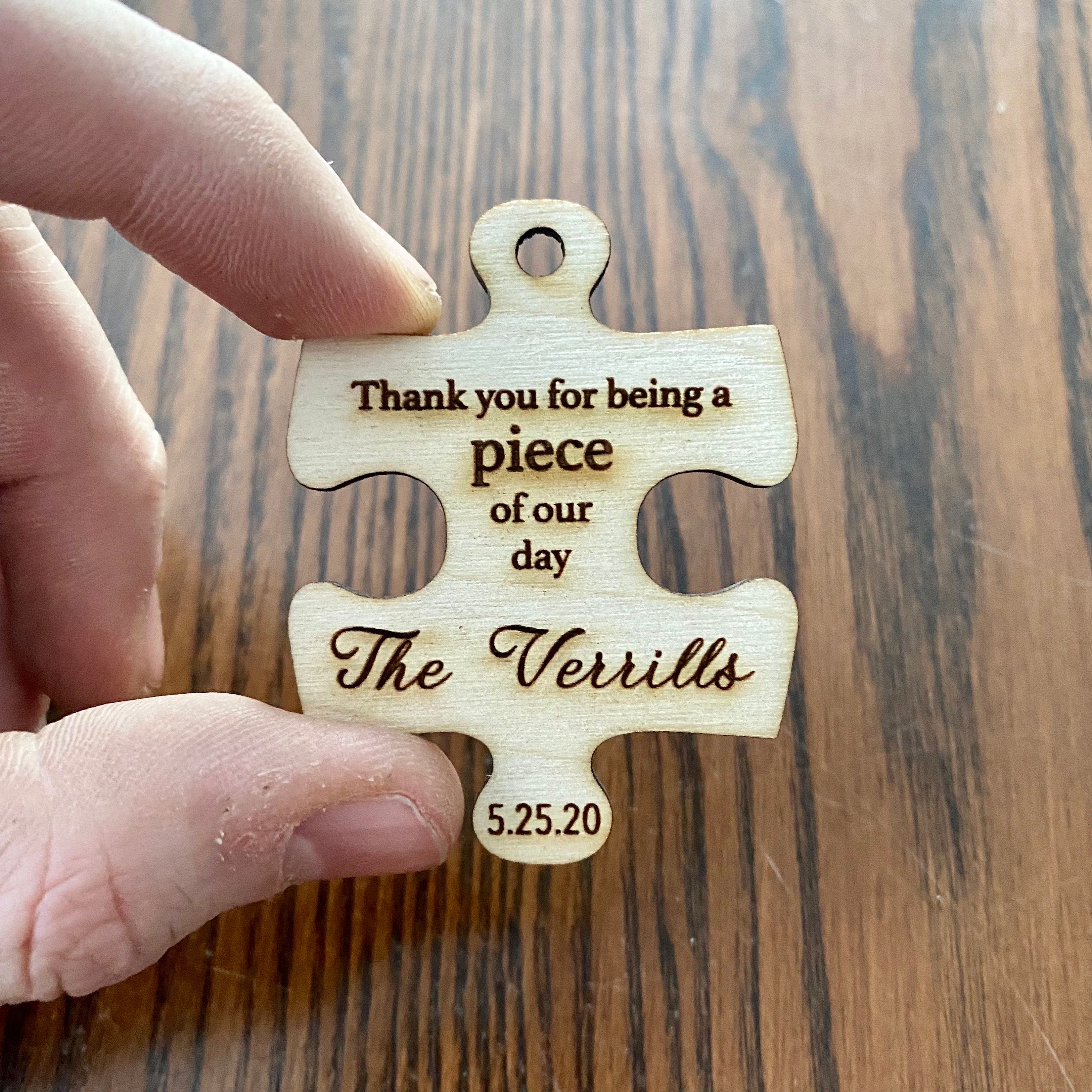 Personalized wooden puzzle piece wedding favor with custom engraving, showcasing rustic charm and durability.