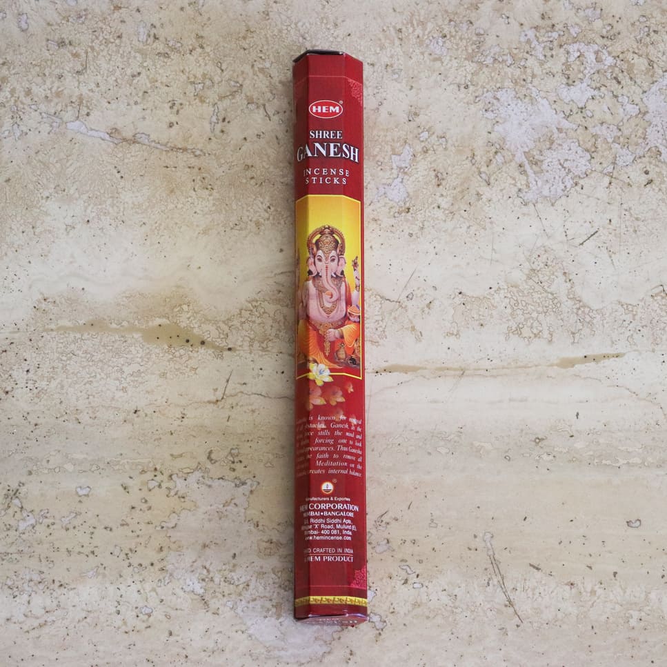 A box of HEM Encens Shree Ganesh incense sticks, featuring a vibrant design and containing hand-rolled sticks, perfect for meditation and relaxation.