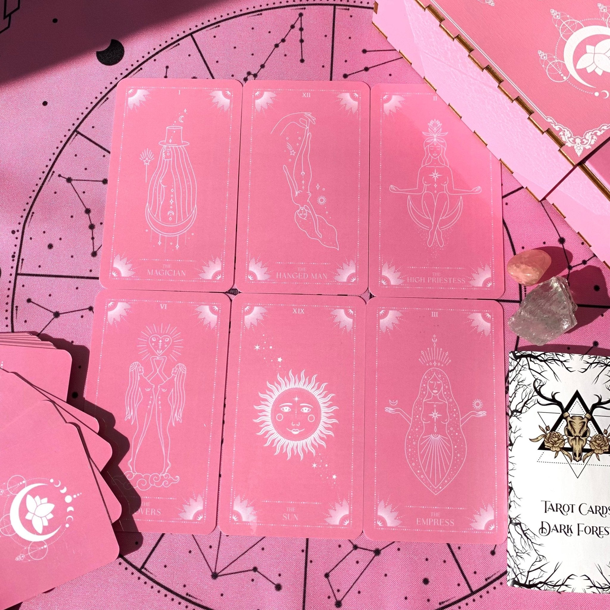 Pink Moon Tarot Deck featuring 78 beautifully designed cards, a guidebook, and accessories including a velvet bag and tarot cloth.