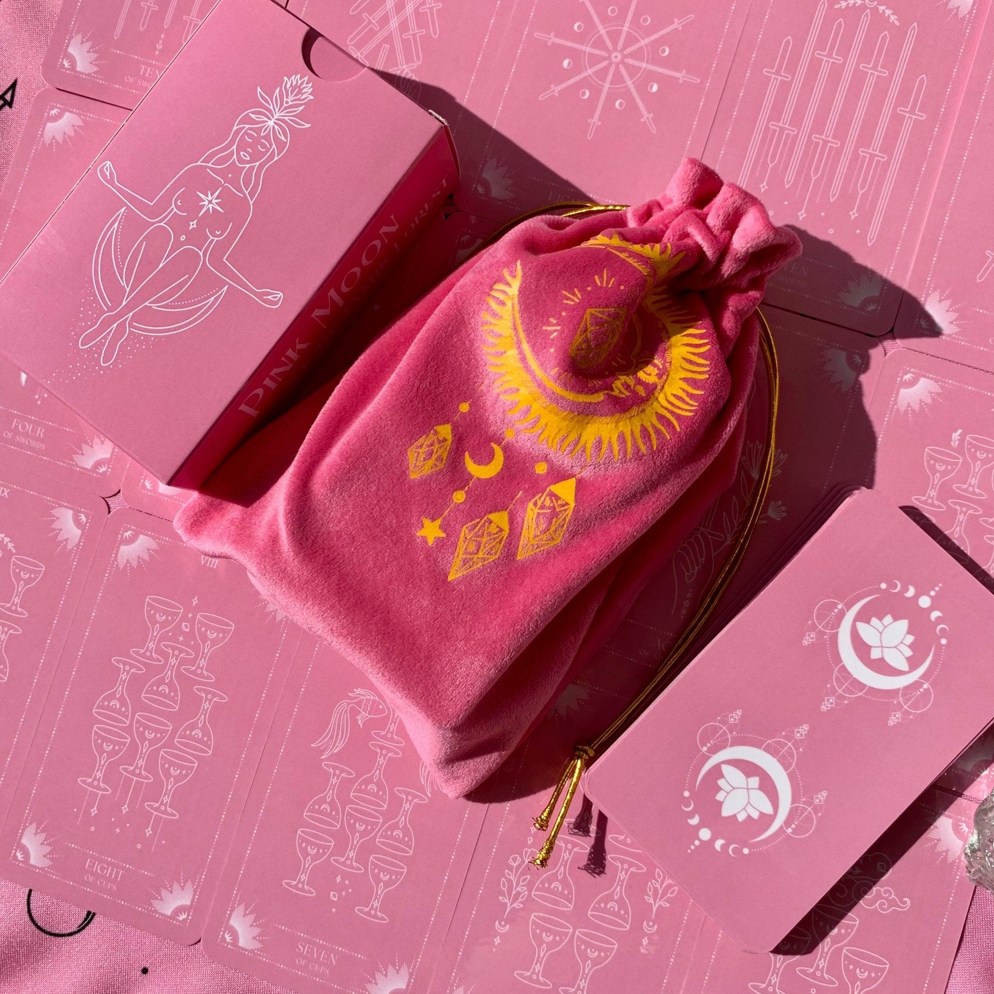 Pink Moon Tarot Deck featuring 78 beautifully designed cards, a guidebook, and accessories including a velvet bag and tarot cloth.