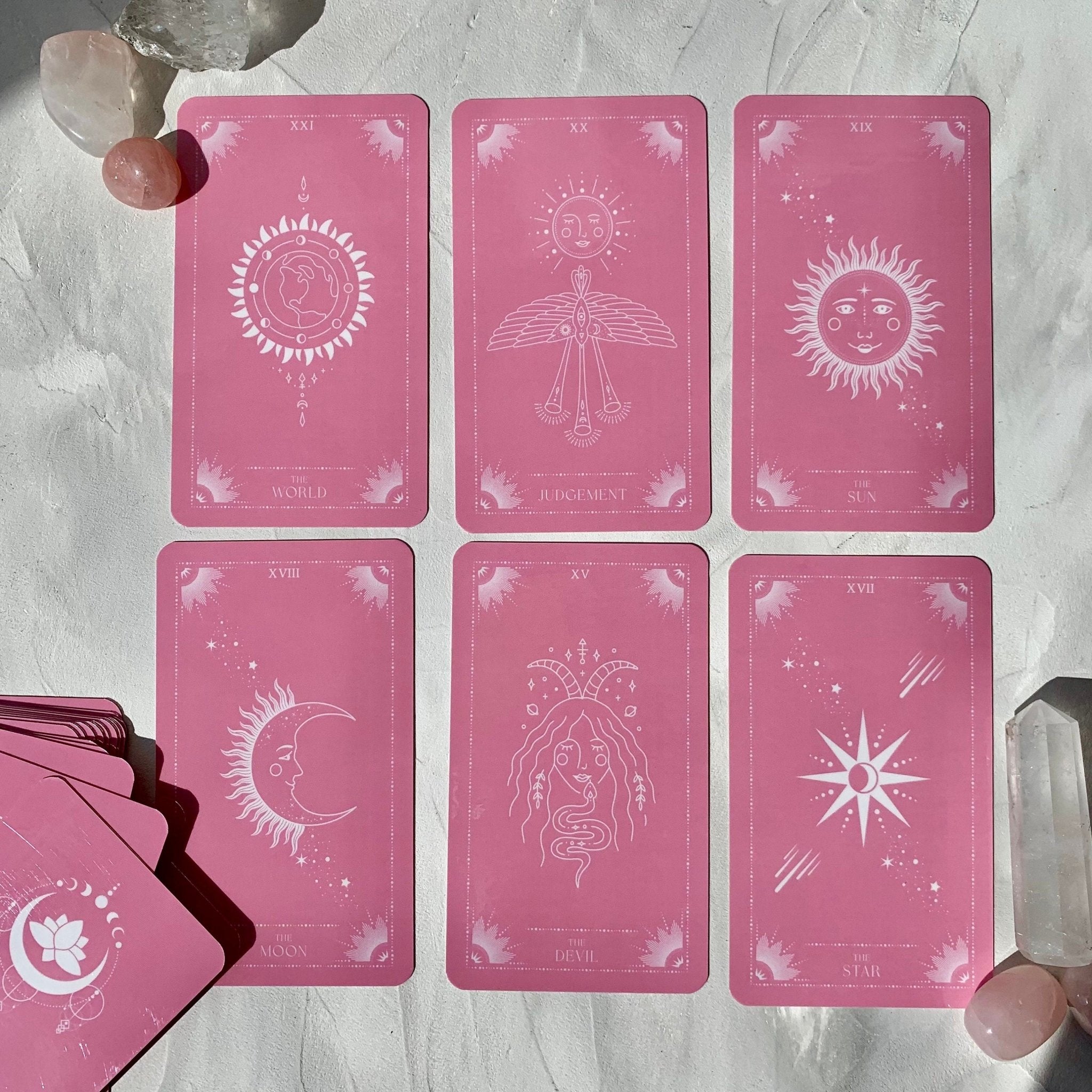 Pink Moon Tarot Deck featuring 78 beautifully designed cards, a guidebook, and accessories including a velvet bag and tarot cloth.