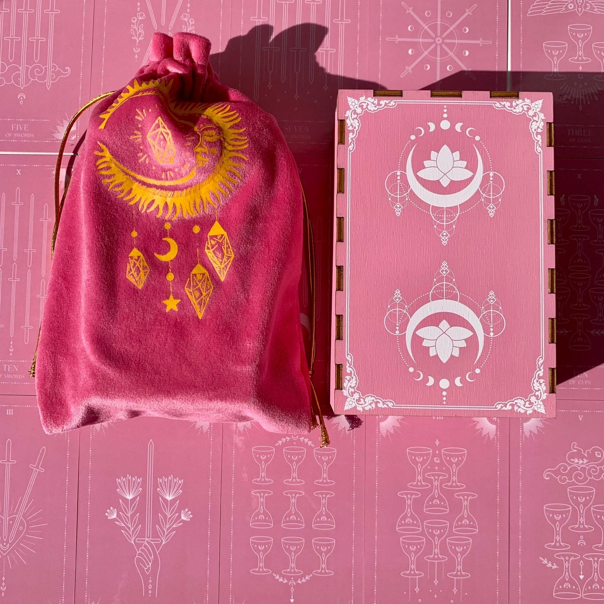 Pink Moon Tarot Deck featuring 78 beautifully designed cards, a guidebook, and accessories including a velvet bag and tarot cloth.