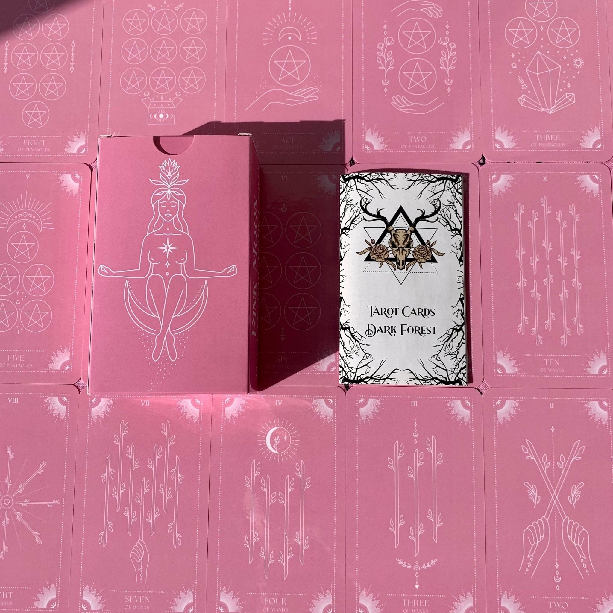 Pink Moon Tarot Deck featuring 78 beautifully designed cards, a guidebook, and accessories including a velvet bag and tarot cloth.