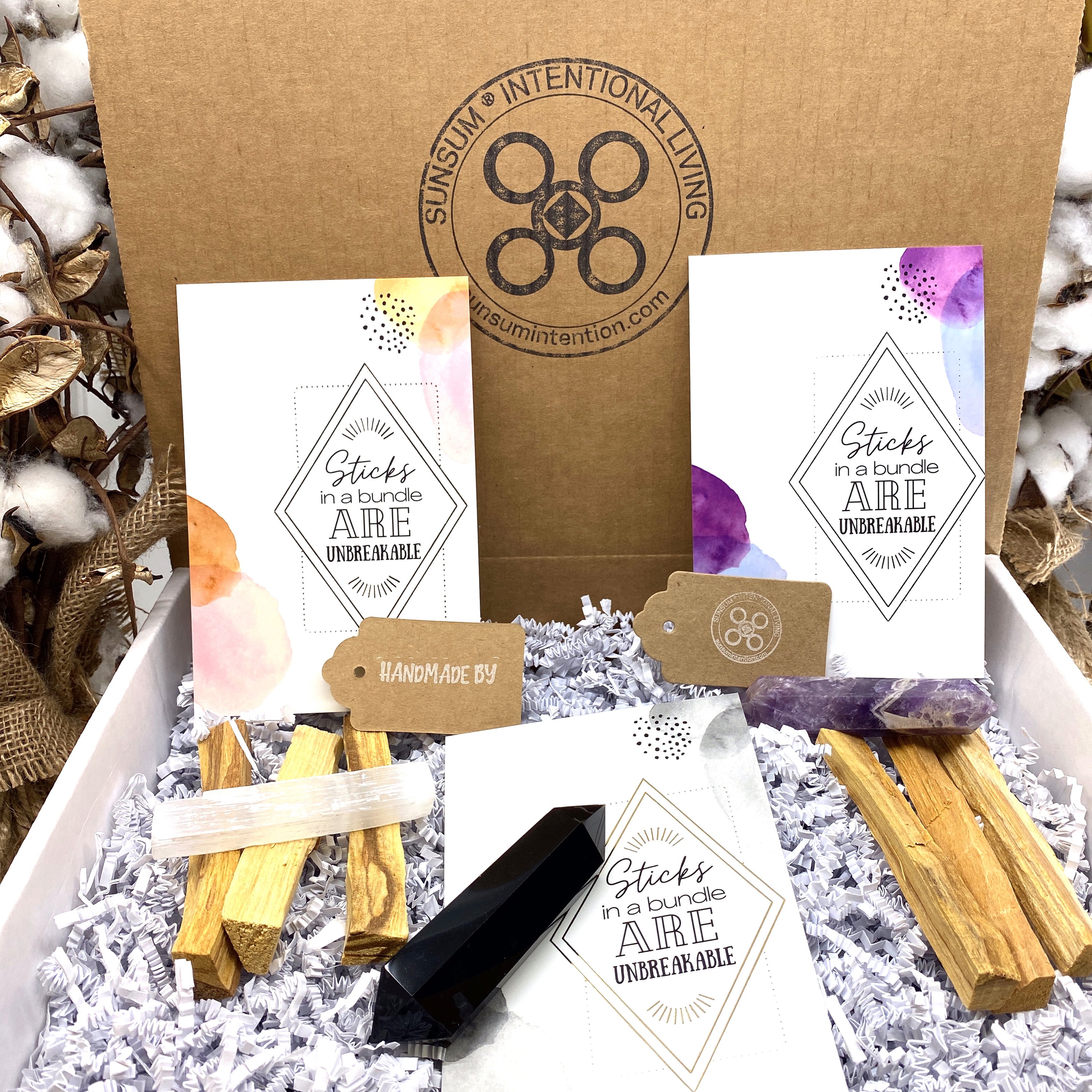 Sunsum® Power of Three Kit featuring an Obsidian Wand, Selenite Wand, Amethyst Wand, and six Palo Santo incense sticks in an elegant gift box.