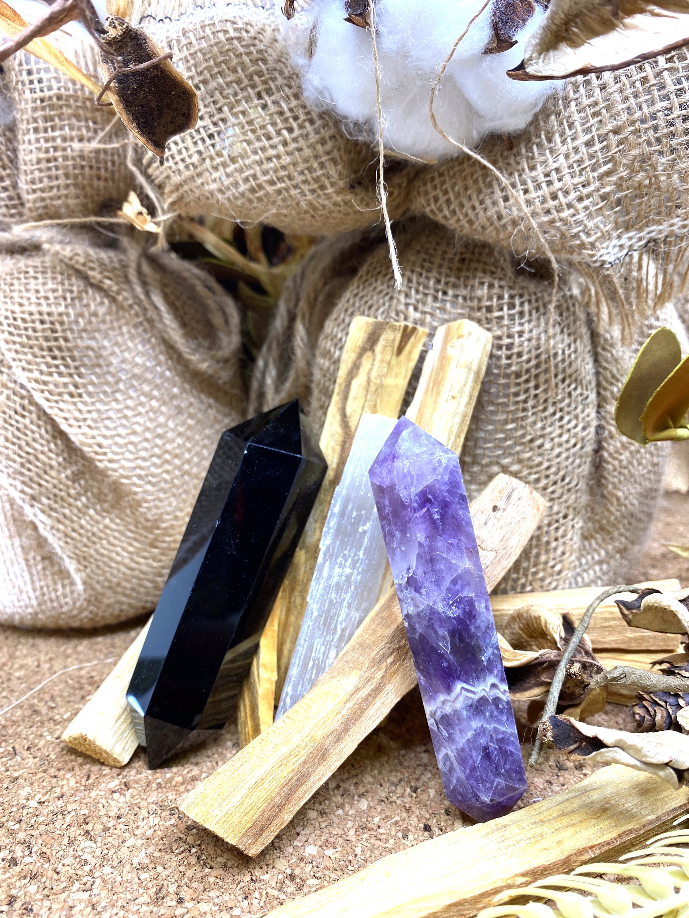 Sunsum® Power of Three Kit featuring an Obsidian Wand, Selenite Wand, Amethyst Wand, and six Palo Santo incense sticks in an elegant gift box.