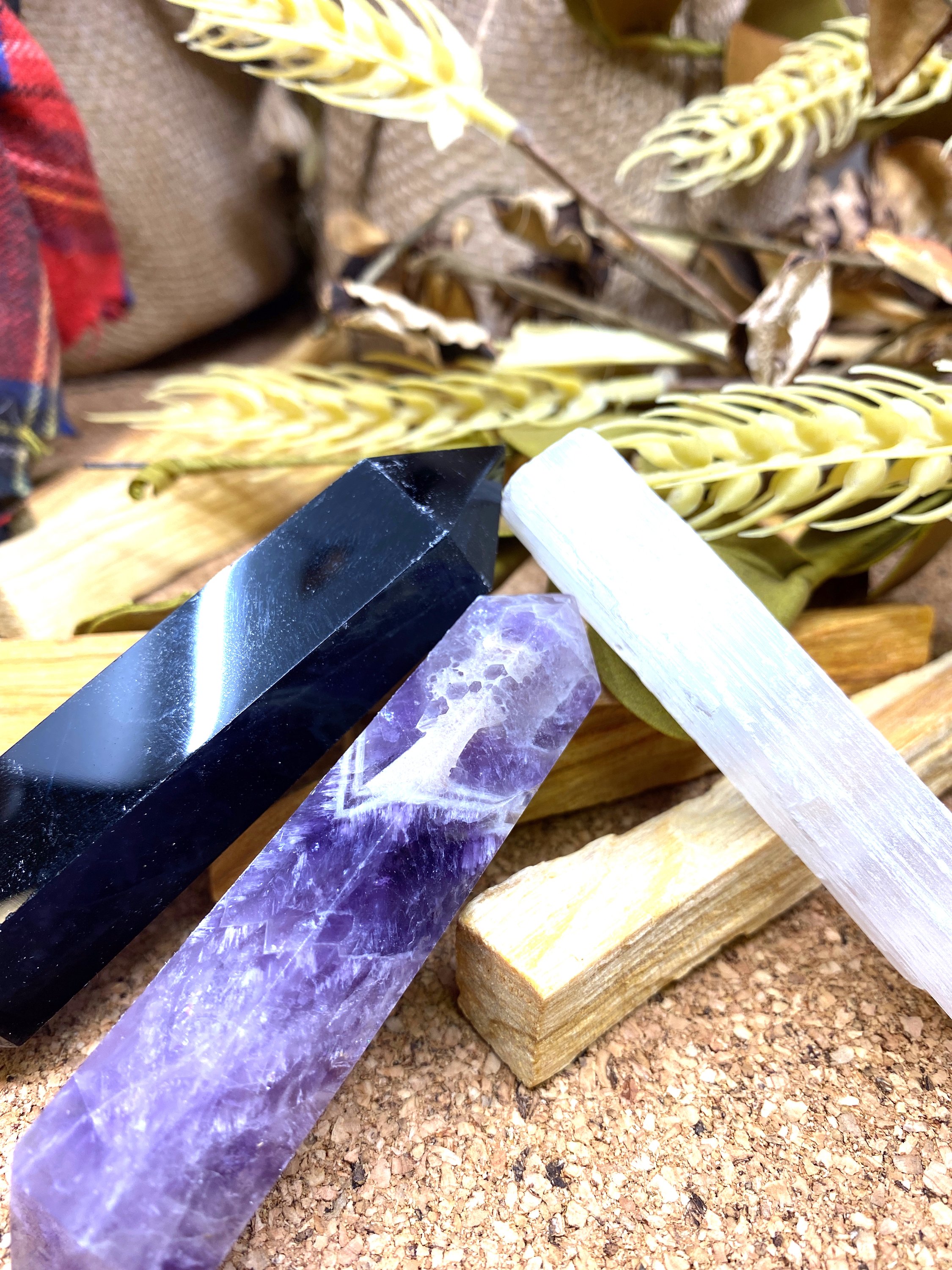 Sunsum® Power of Three Kit featuring an Obsidian Wand, Selenite Wand, Amethyst Wand, and six Palo Santo incense sticks in an elegant gift box.