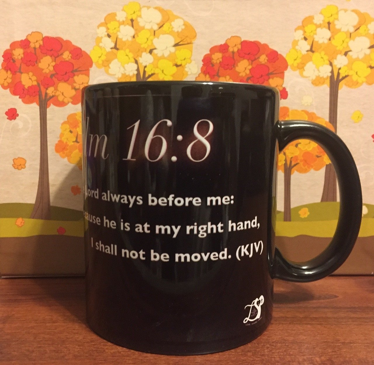 Black glossy ceramic mug featuring the biblical verse Psalms 16:8, perfect for daily use.