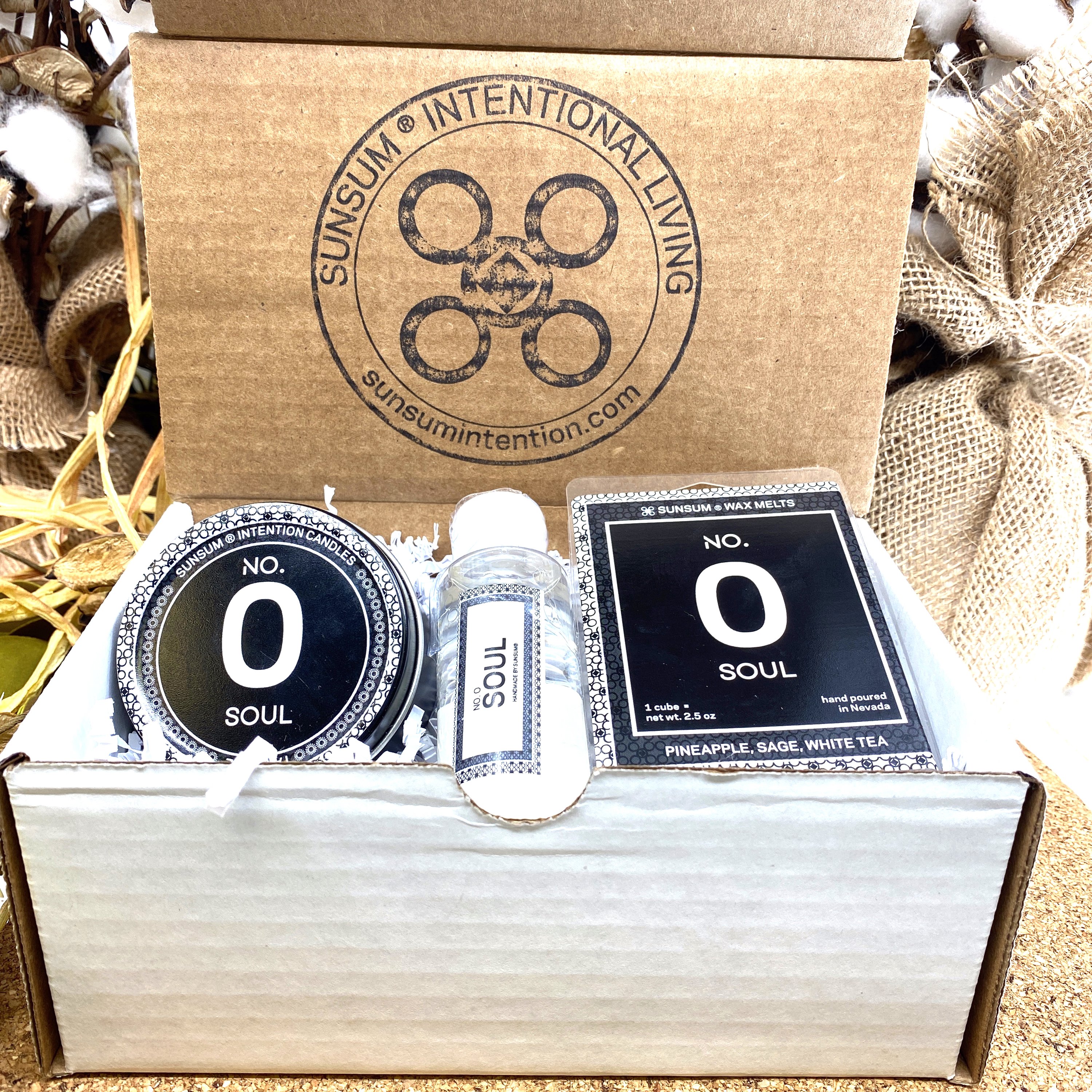 Spirit Number 000 Gift Set featuring handmade products including candles, body oils, and wax melts with aromas of pineapple, sage, and white tea.